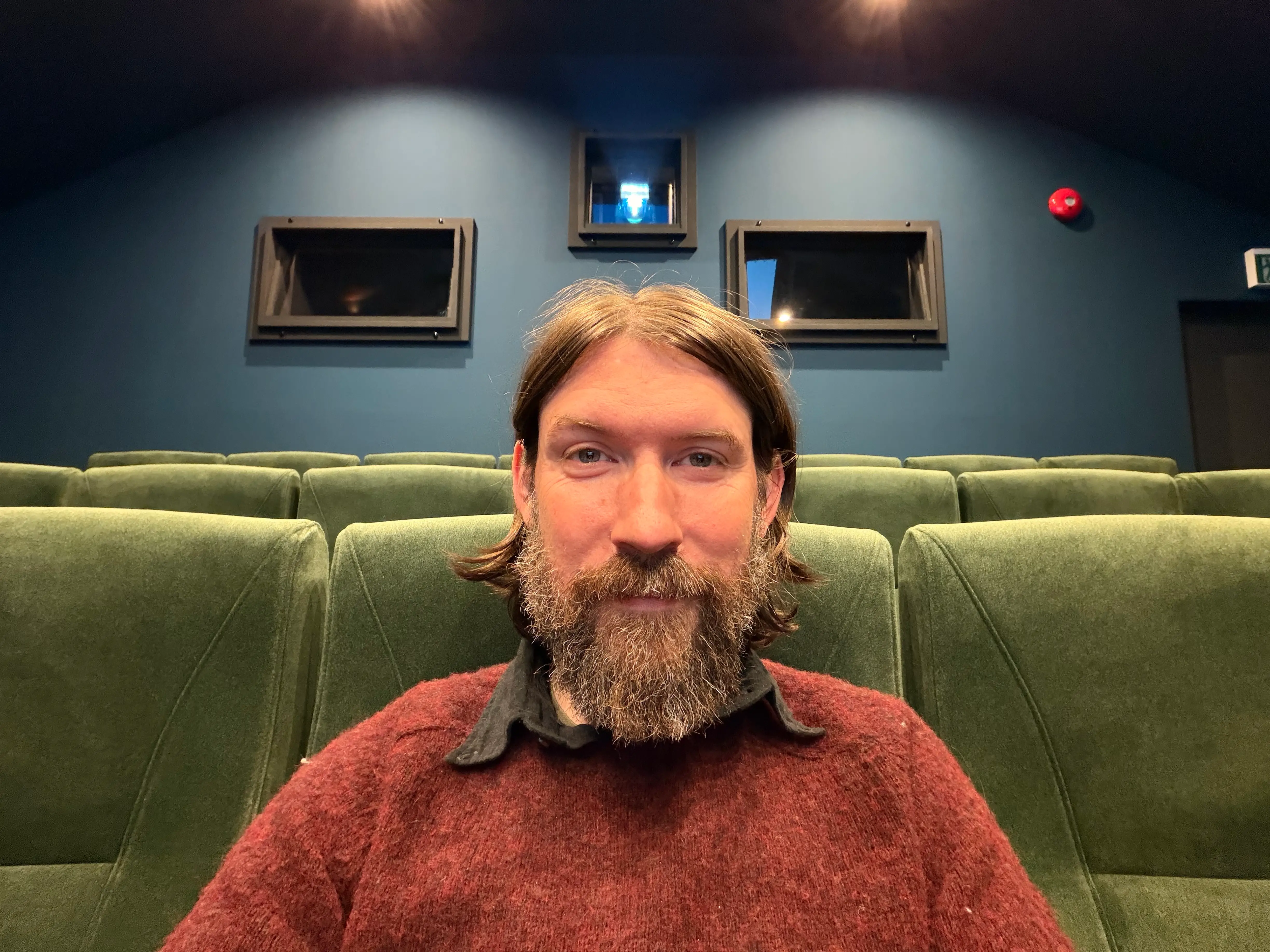 Matthew Kelson sitting at a movie theater in Japan.