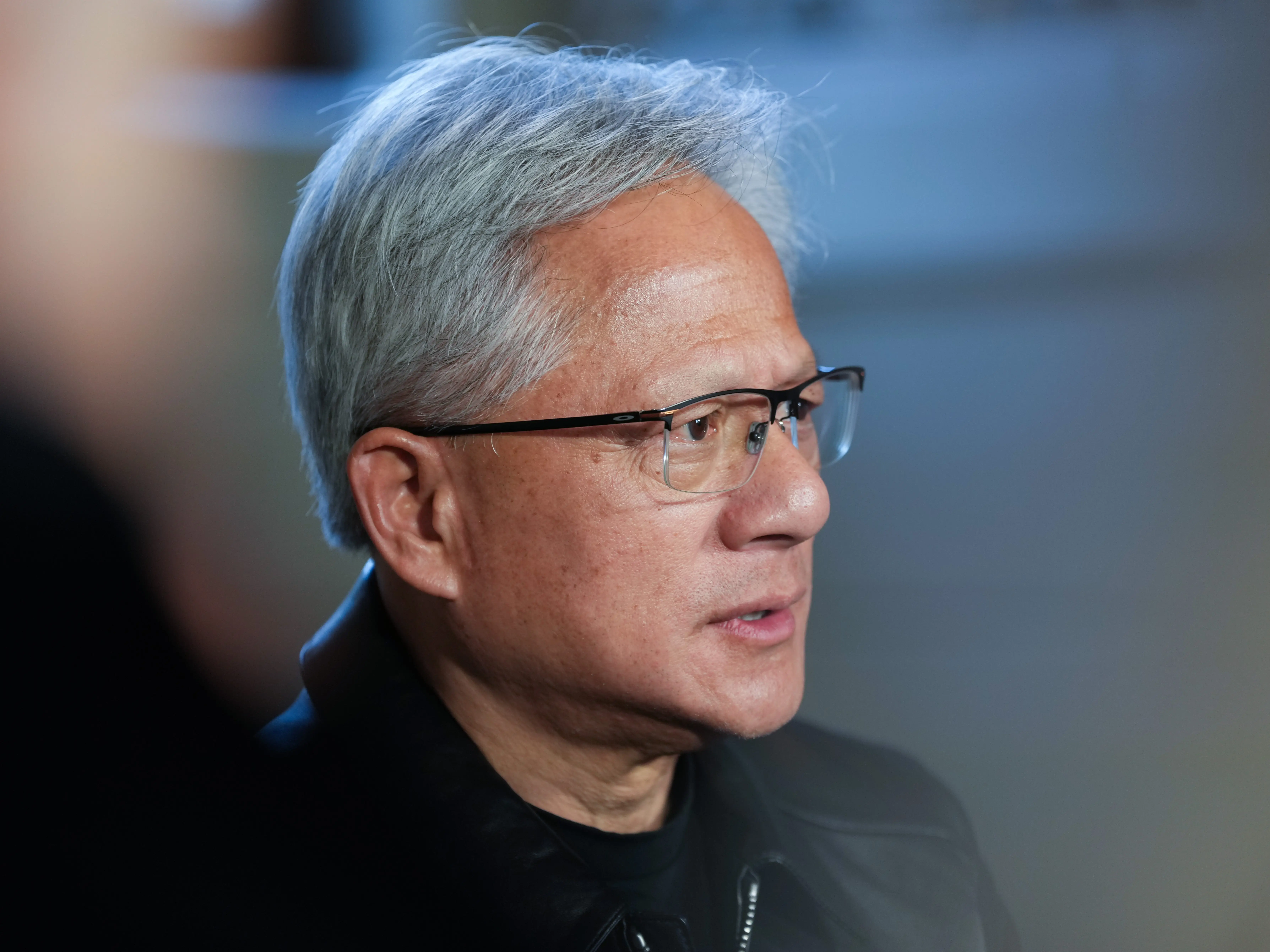 Jensen Huang in Stockholm, seen from a profile with a blurry background.