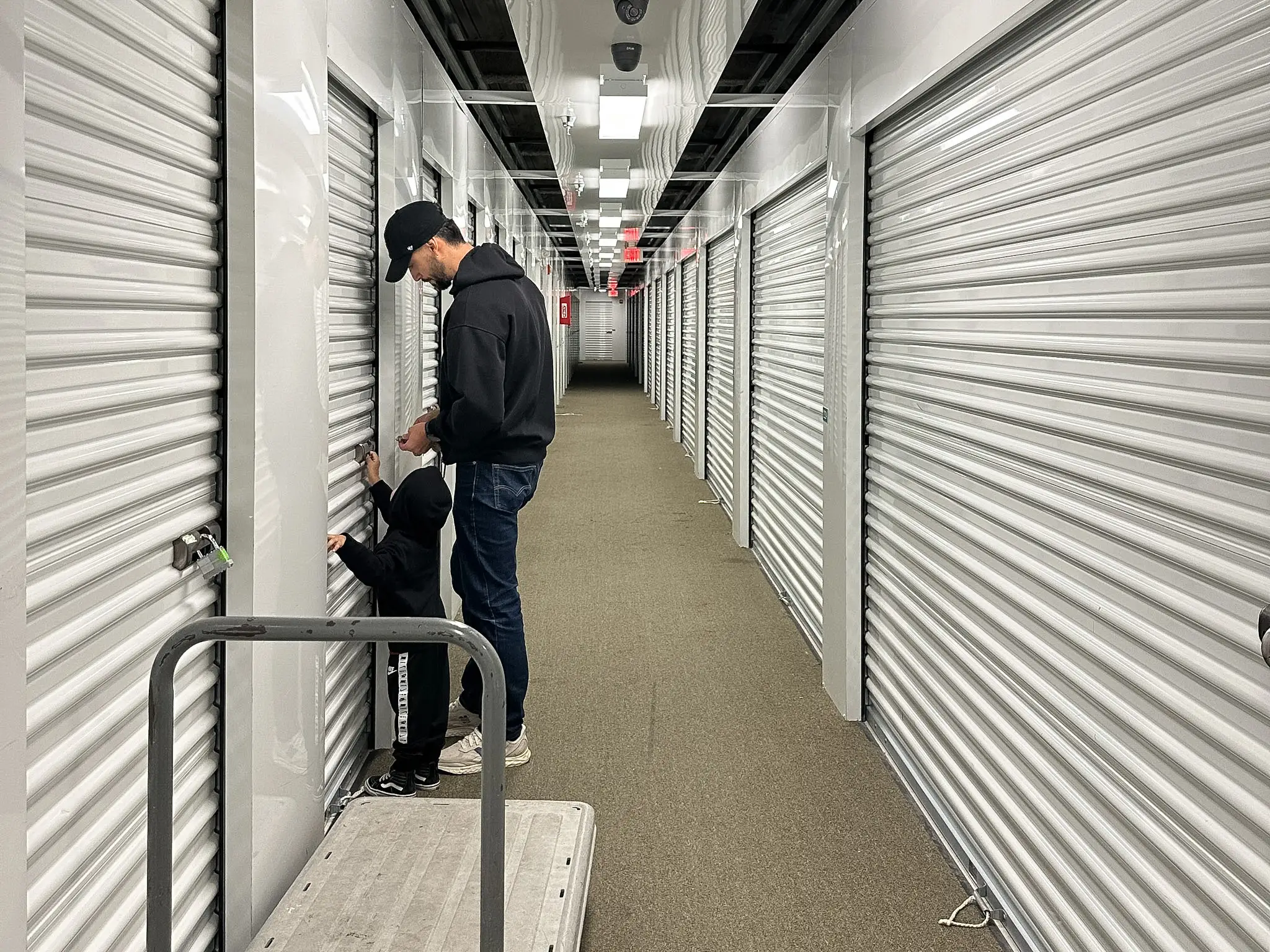 Yaritza's son helps his dad open a storage unit.