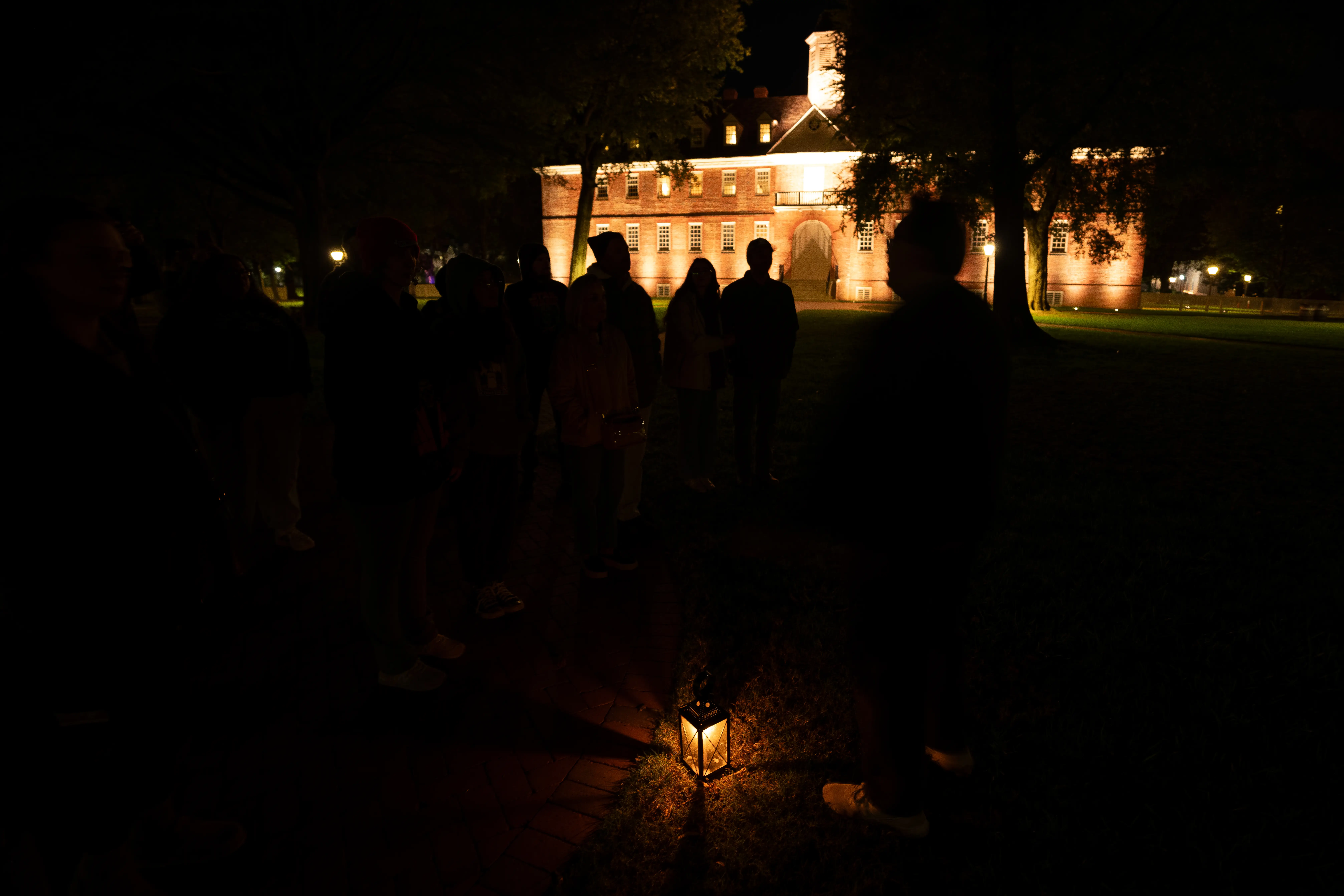 Tour guide Ben Payson tells stories while walking through Wren Yard at the College of William & Mary during a tour titled