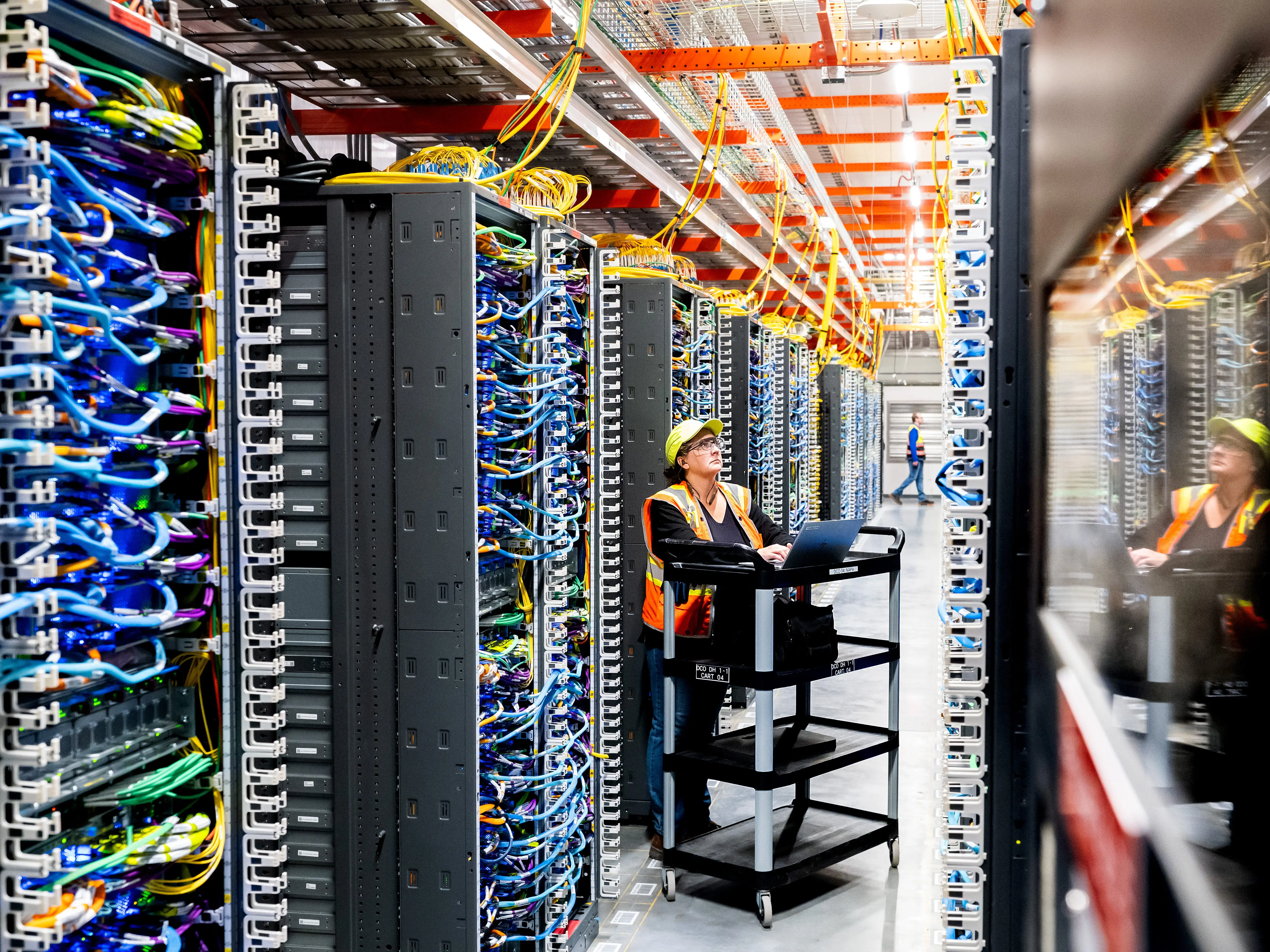 NEW CARLISLE, INDIANA - OCTOBER 2: In this handout provided by Amazon, a technician works at an Amazon Web Services AI data center in New Carlisle, Indiana on October 2, 2025.
