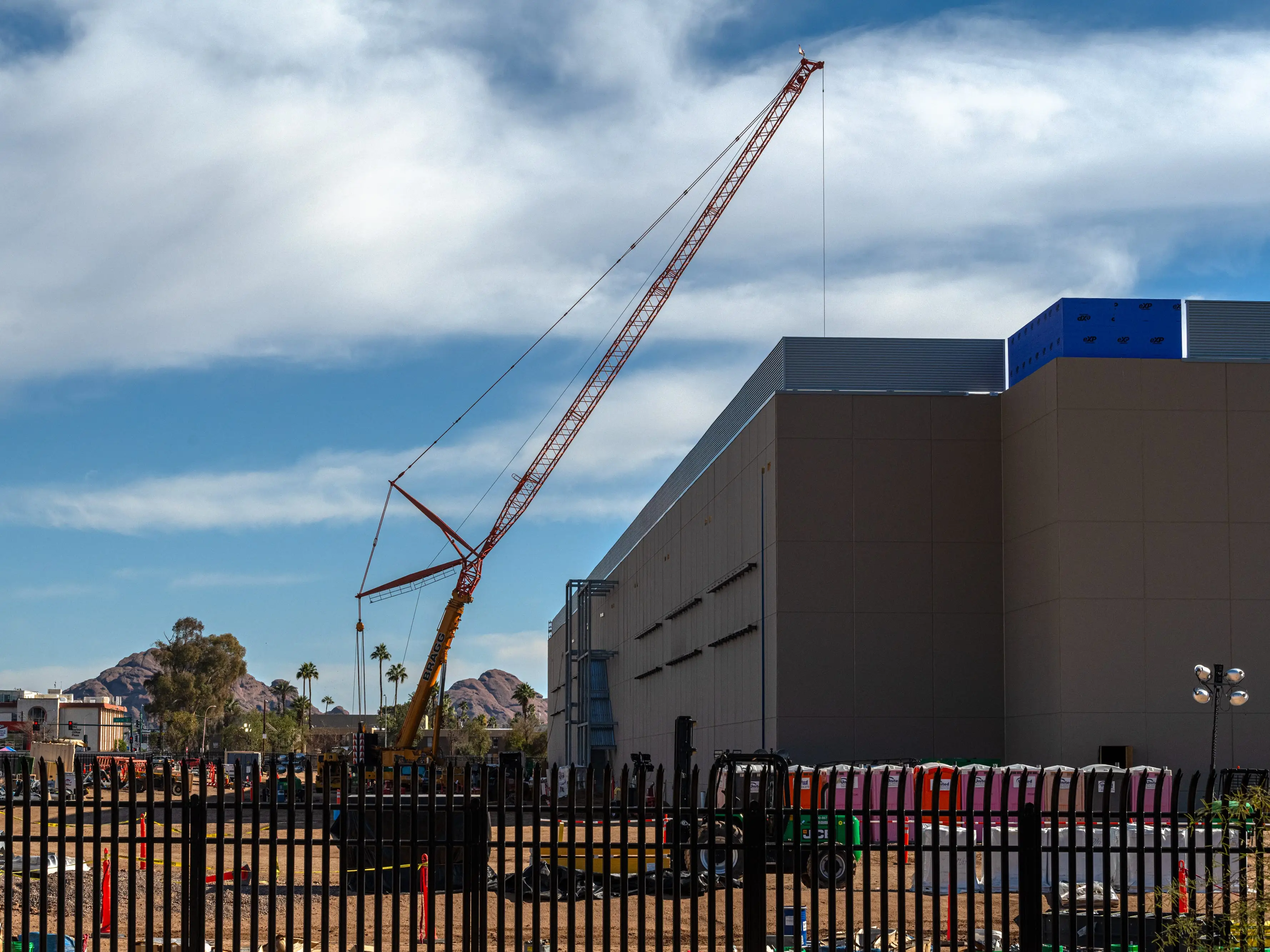A data center under construction under a blue sky.