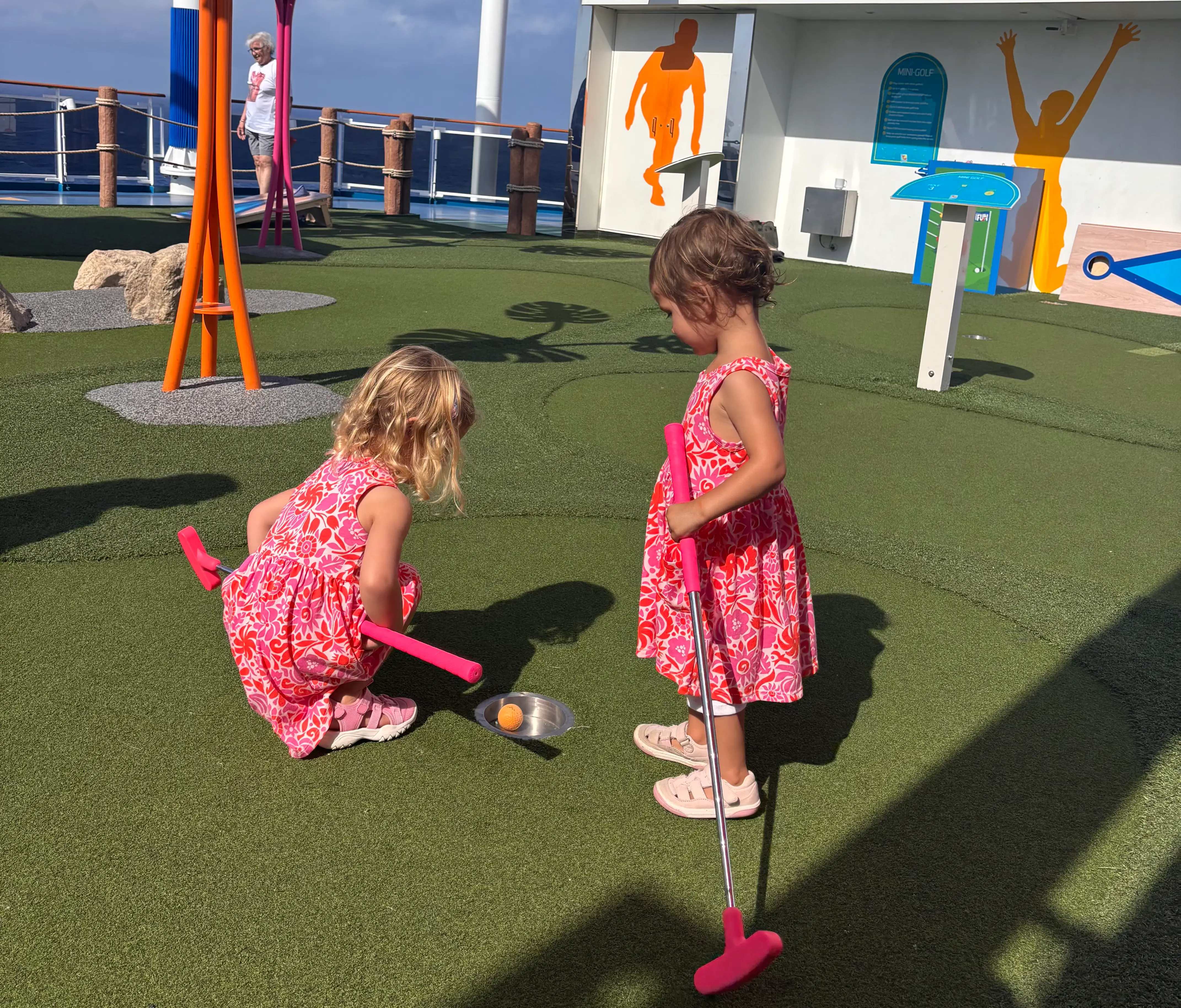 Two kids on mini golf course on cruise ship