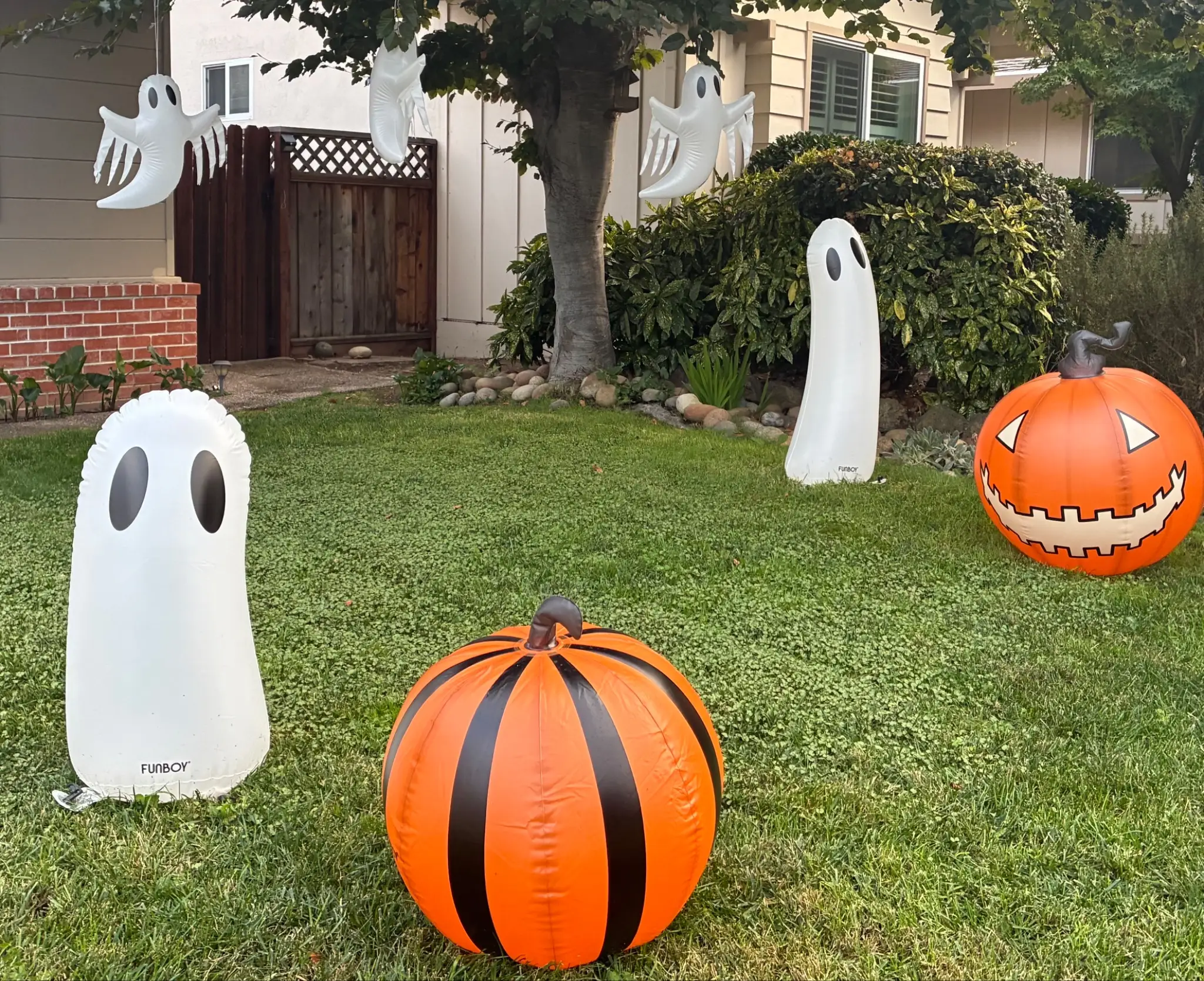 Halloween ghost decorations on a lawn in Silicon Valley.