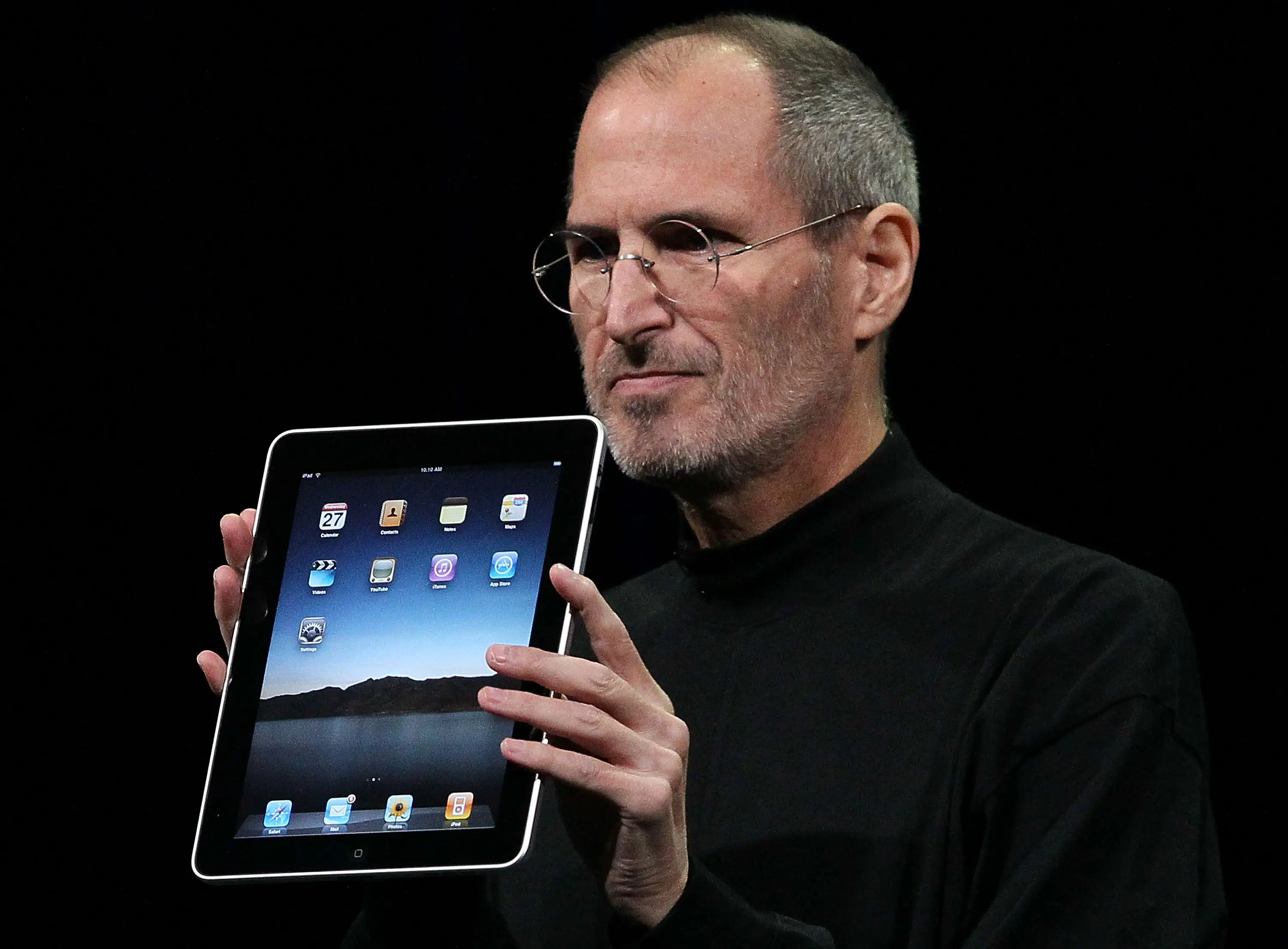 SAN FRANCISCO - JANUARY 27: Apple Inc. CEO Steve Jobs holds up the new iPad as he speaks during an Apple Special Event at Yerba Buena Center for the Arts January 27, 2010 in San Francisco, California. Apple introduced its latest creation, the iPad, a mobile tablet browsing device that is a cross between the iPhone and a MacBook laptop. (Photo by Justin Sullivan/Getty Images)