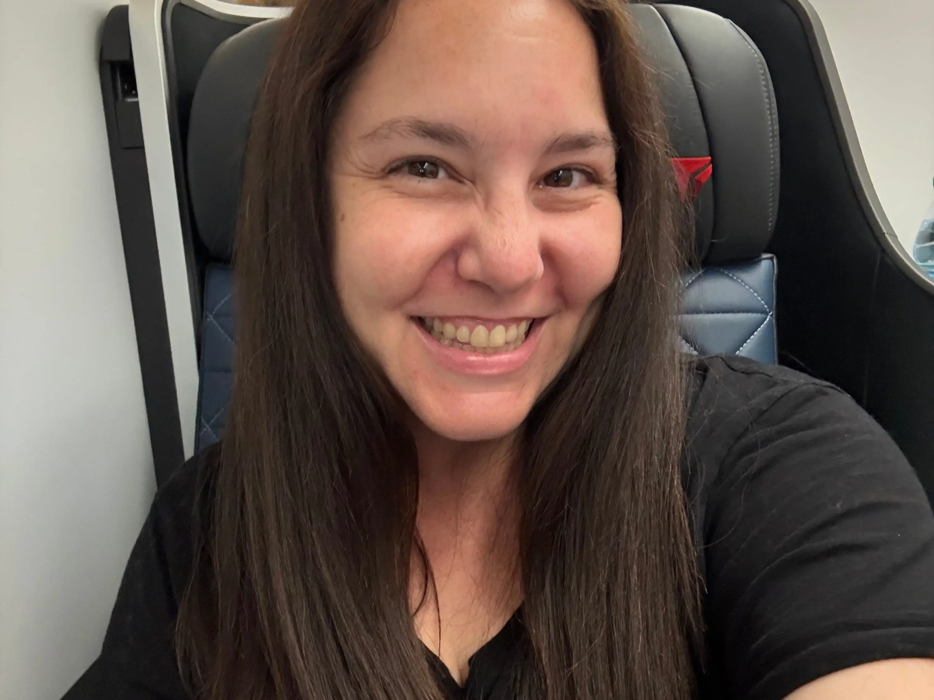 selfie of the author on a plane in a black tshirt
