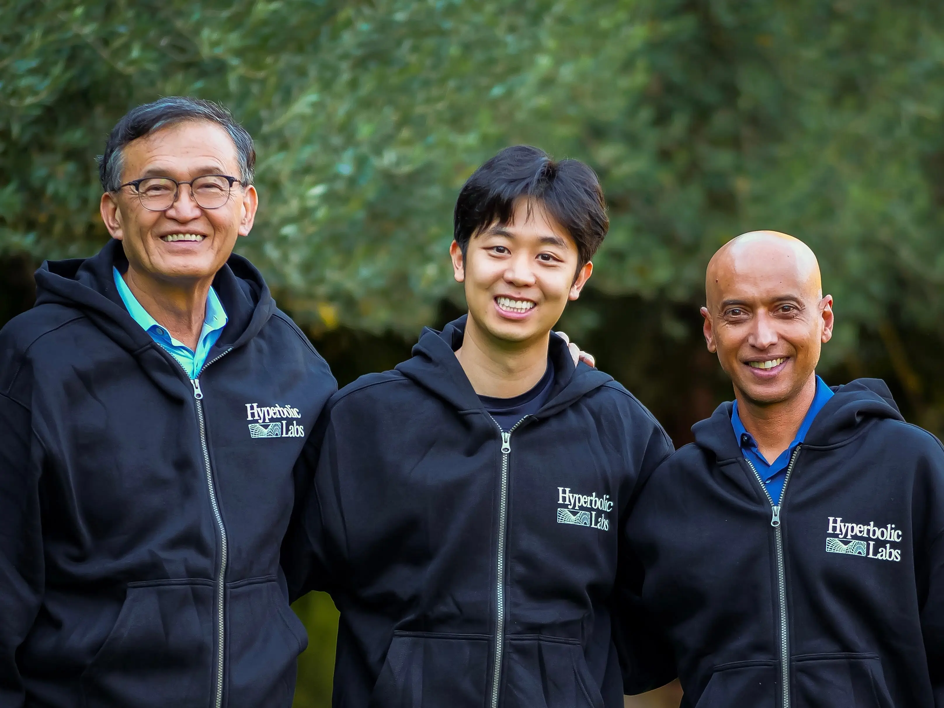 Intel CEO Lip-Bu, Hyperbolic founder Jasper Zhang, and Walden Catalyst partner Shankar Chandran -- all wearing blue hoodies with the Hyperbolic logo.