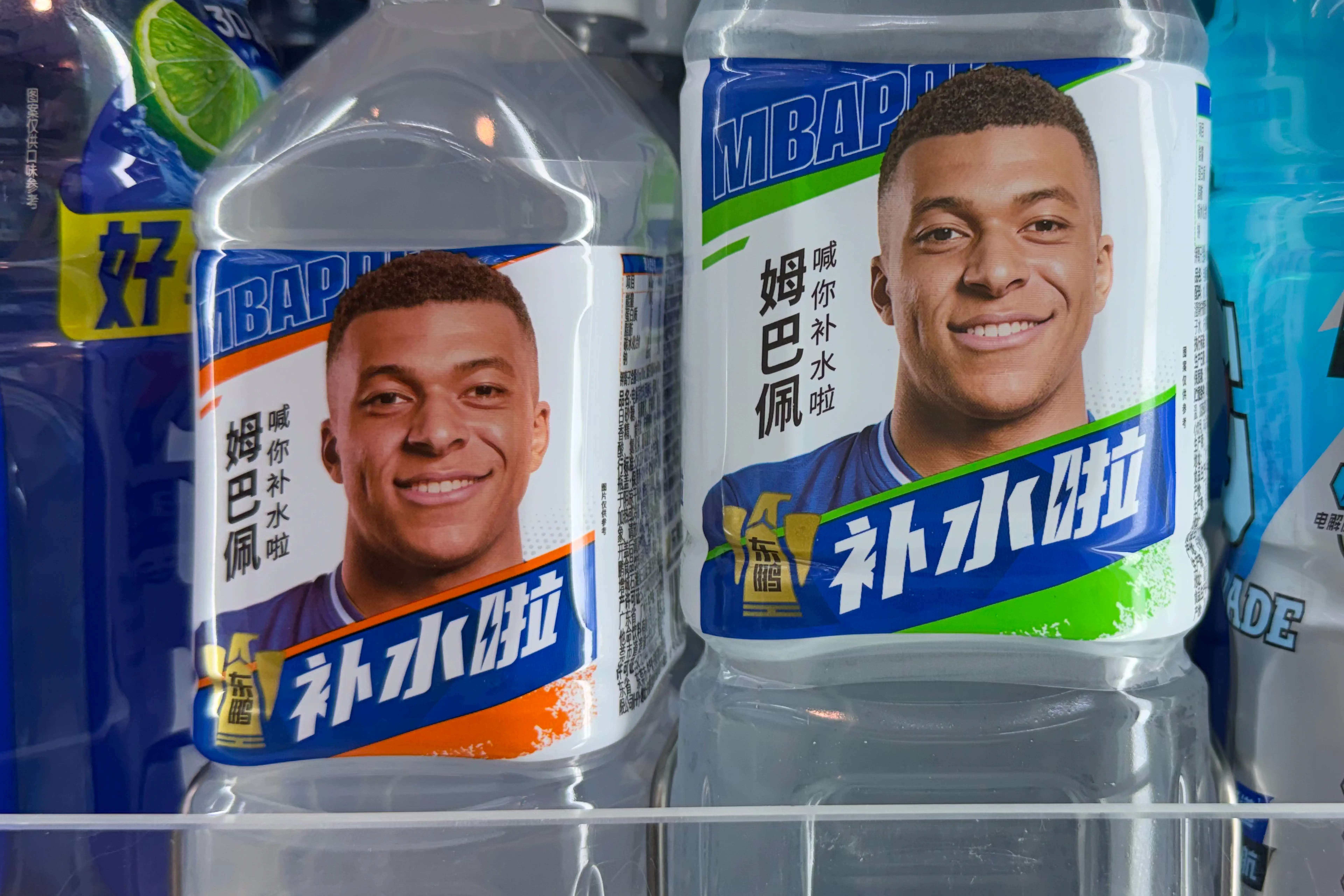SHANGHAI, CHINA - OCTOBER 27: Bottles of Dongpeng electrolyte drink endorsed by French football star Kylian Mbappe are displayed on a shelf at a convenience store on October 27, 2026 in Shanghai, China. (Photo by VCG/VCG via Getty Images)