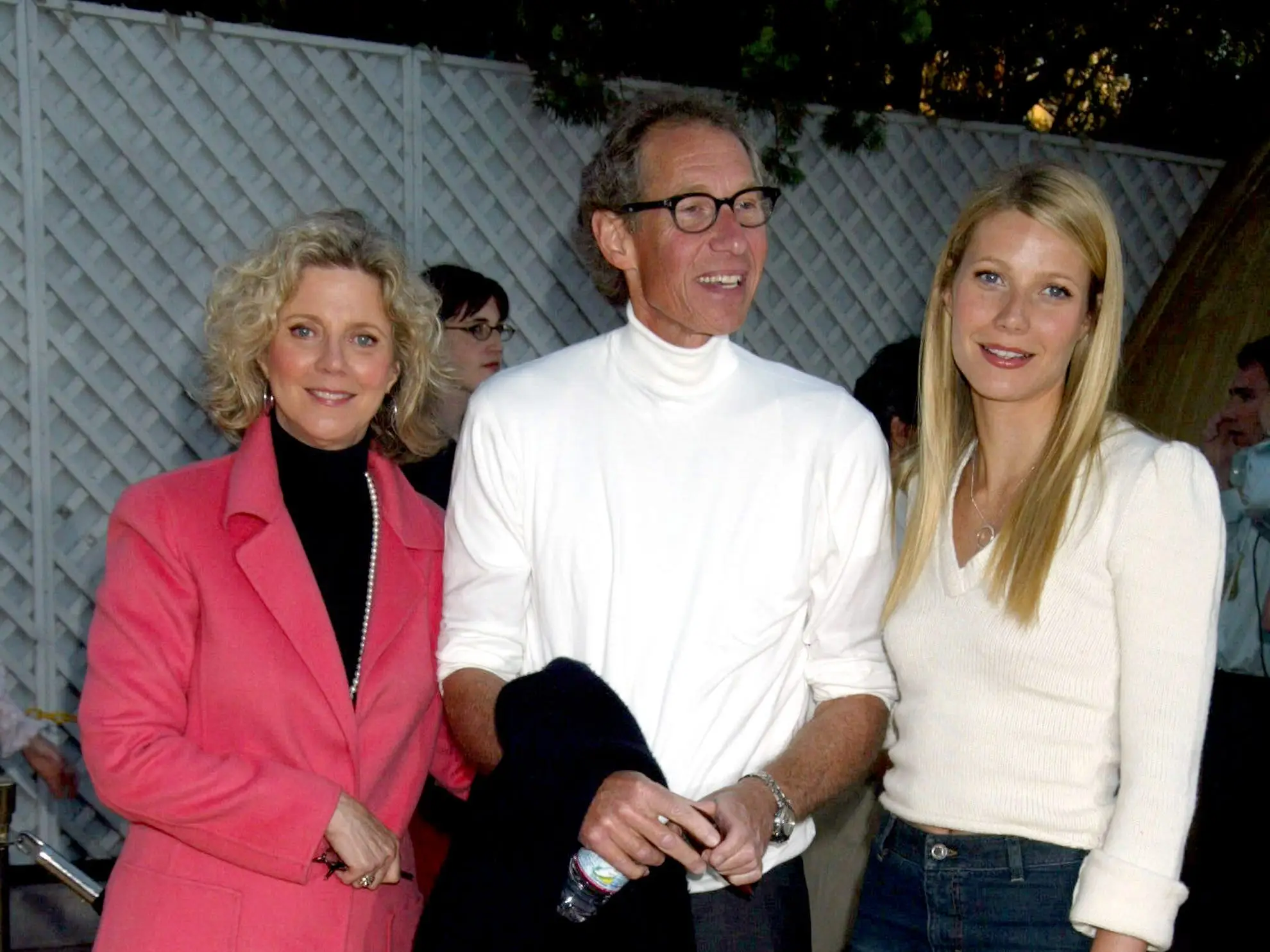 Blythe Danner, Bruce Paltrow, and Gwyneth Paltrow stand together at an outdoor event.