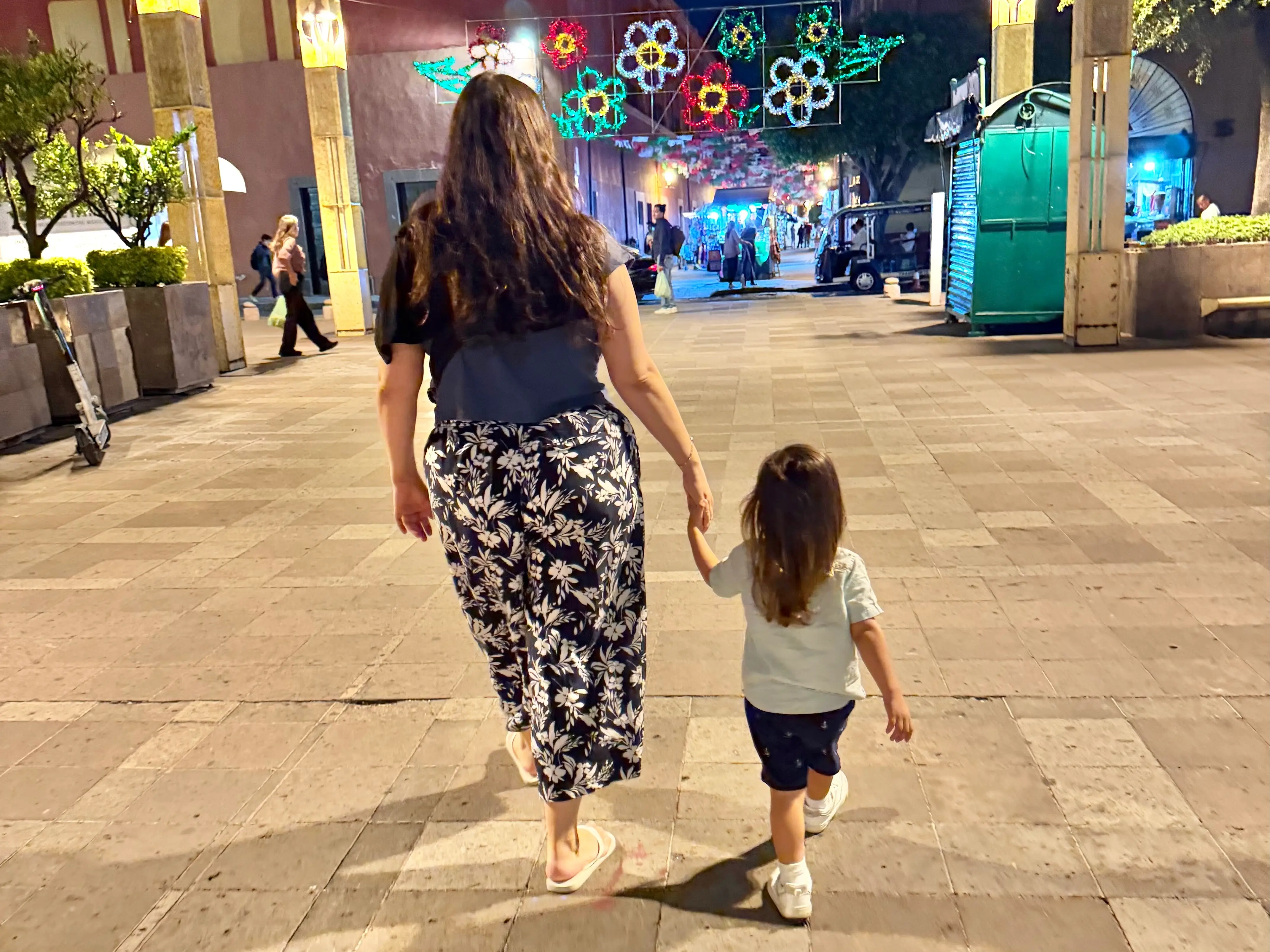Woman holding child's hand