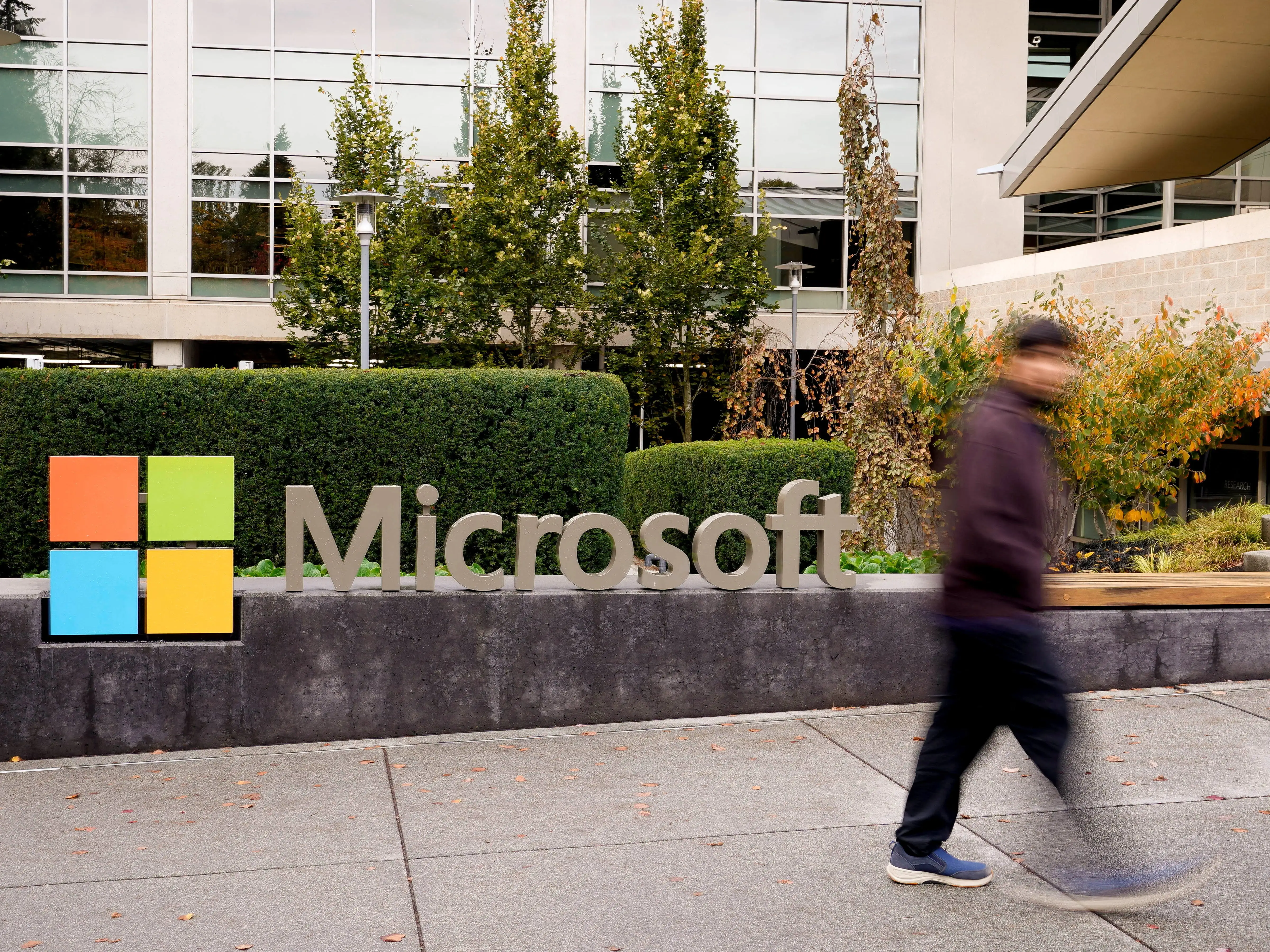 A man walks past a sign on the Microsoft campus in Redmond, Washington