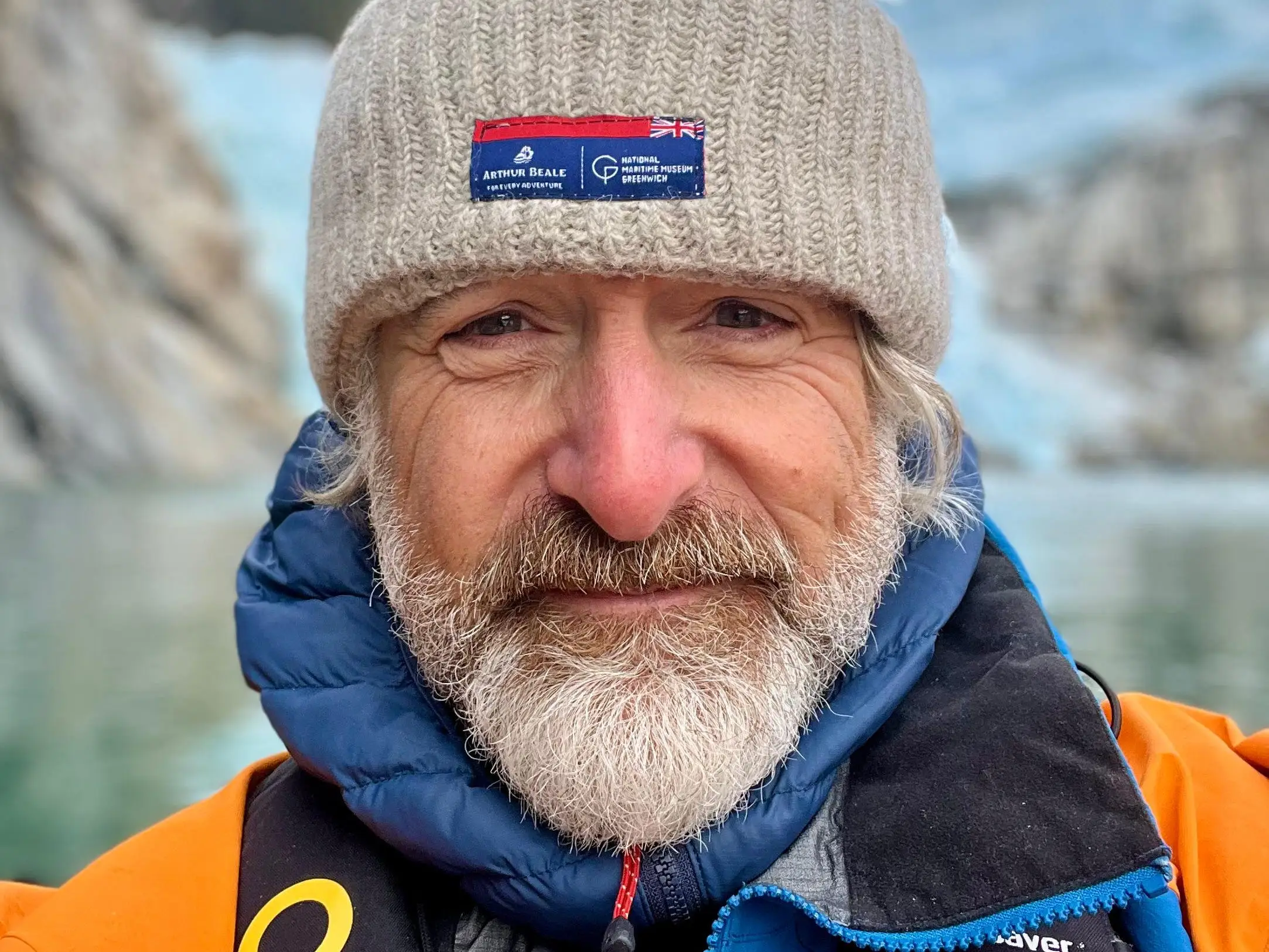 photo of a man in antarctica with a beanie.