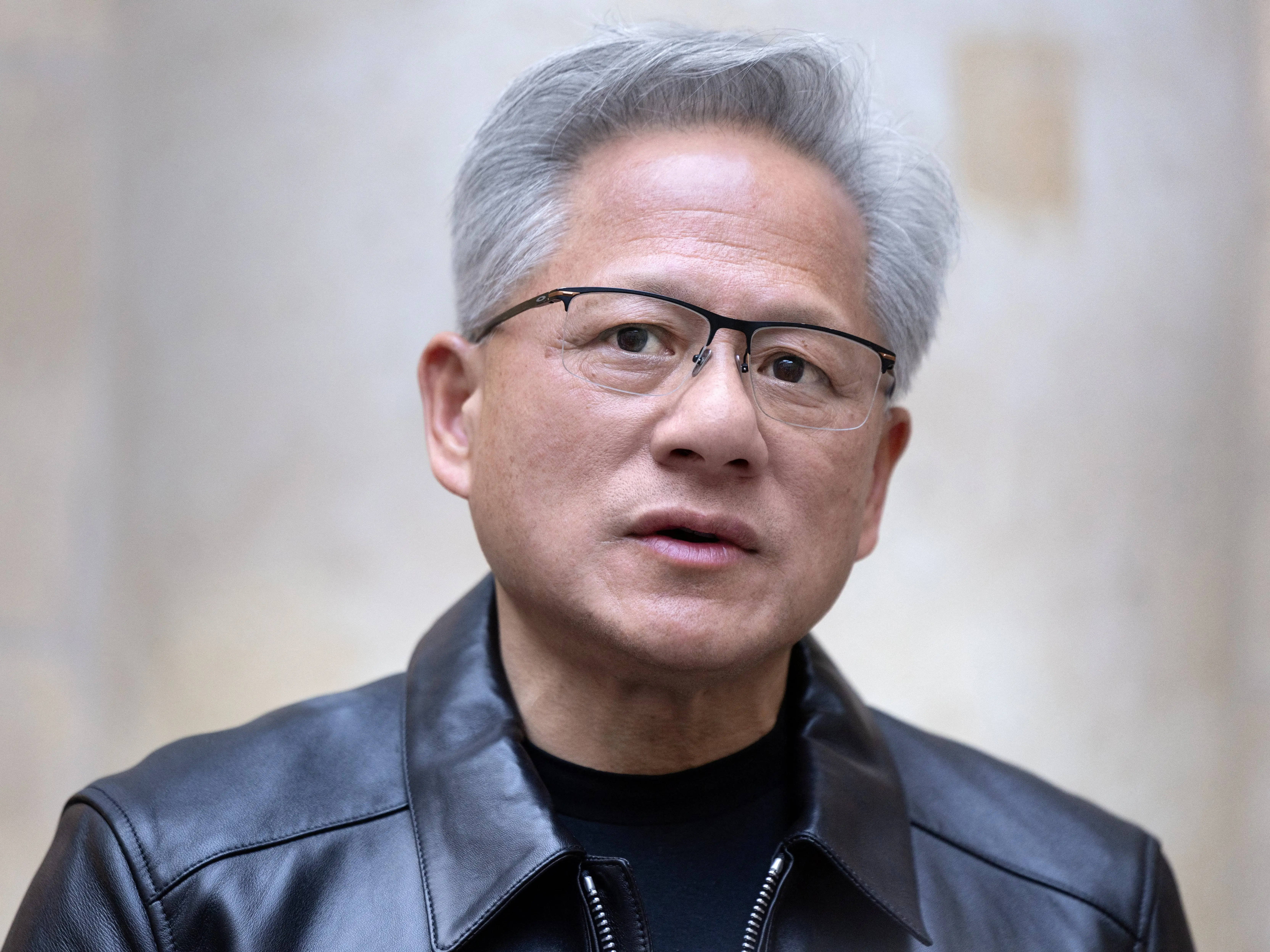 Co-founder, President and CEO of US technology company Nvidia, Jensen Huang, looks on during a press briefing in Paris on October 13, 2026.