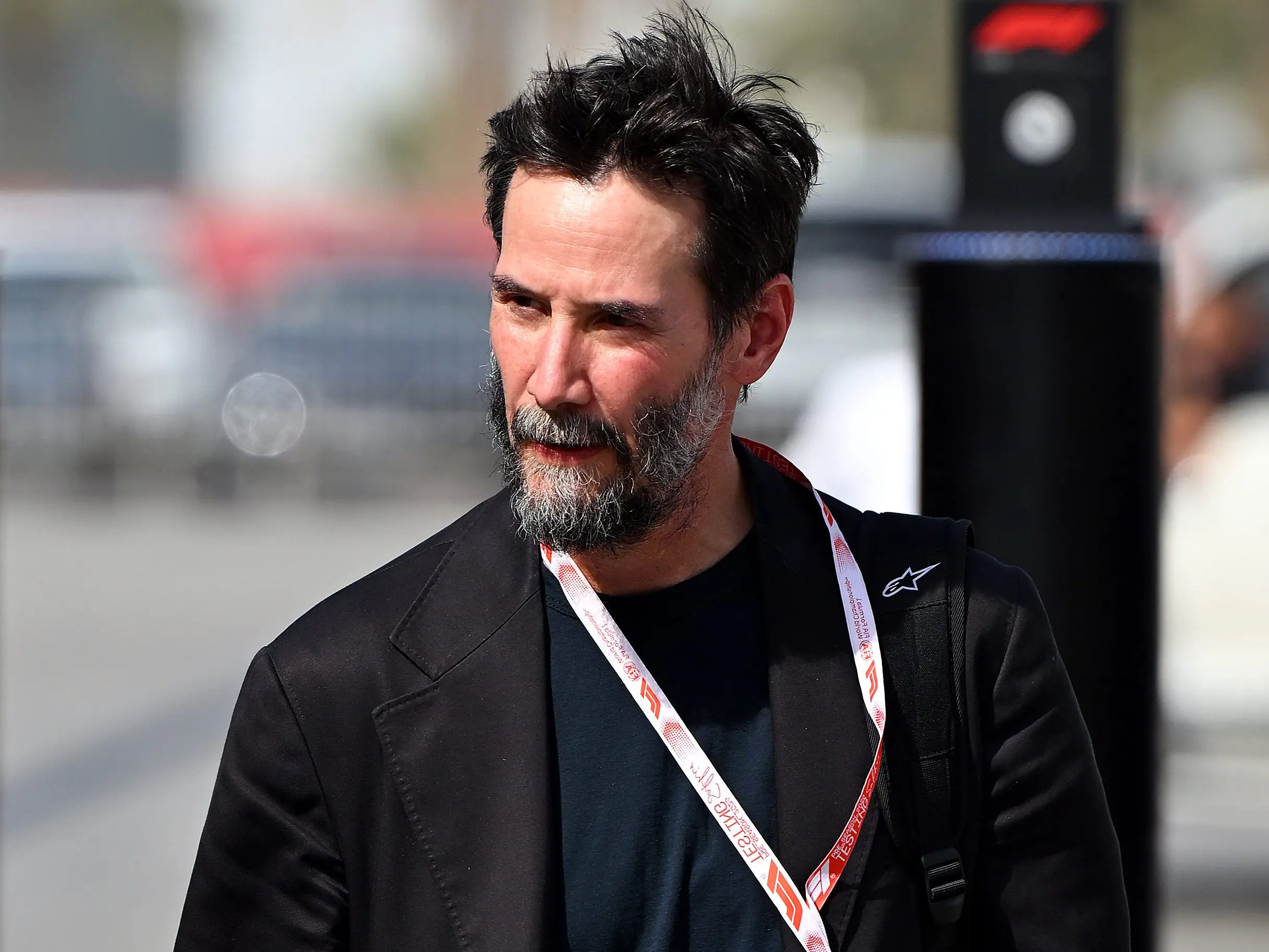 Keanu Reeves enters the Paddock during day two of F1 Testing at Bahrain International Circuit on February 12, 2026 in Bahrain, Bahrain.