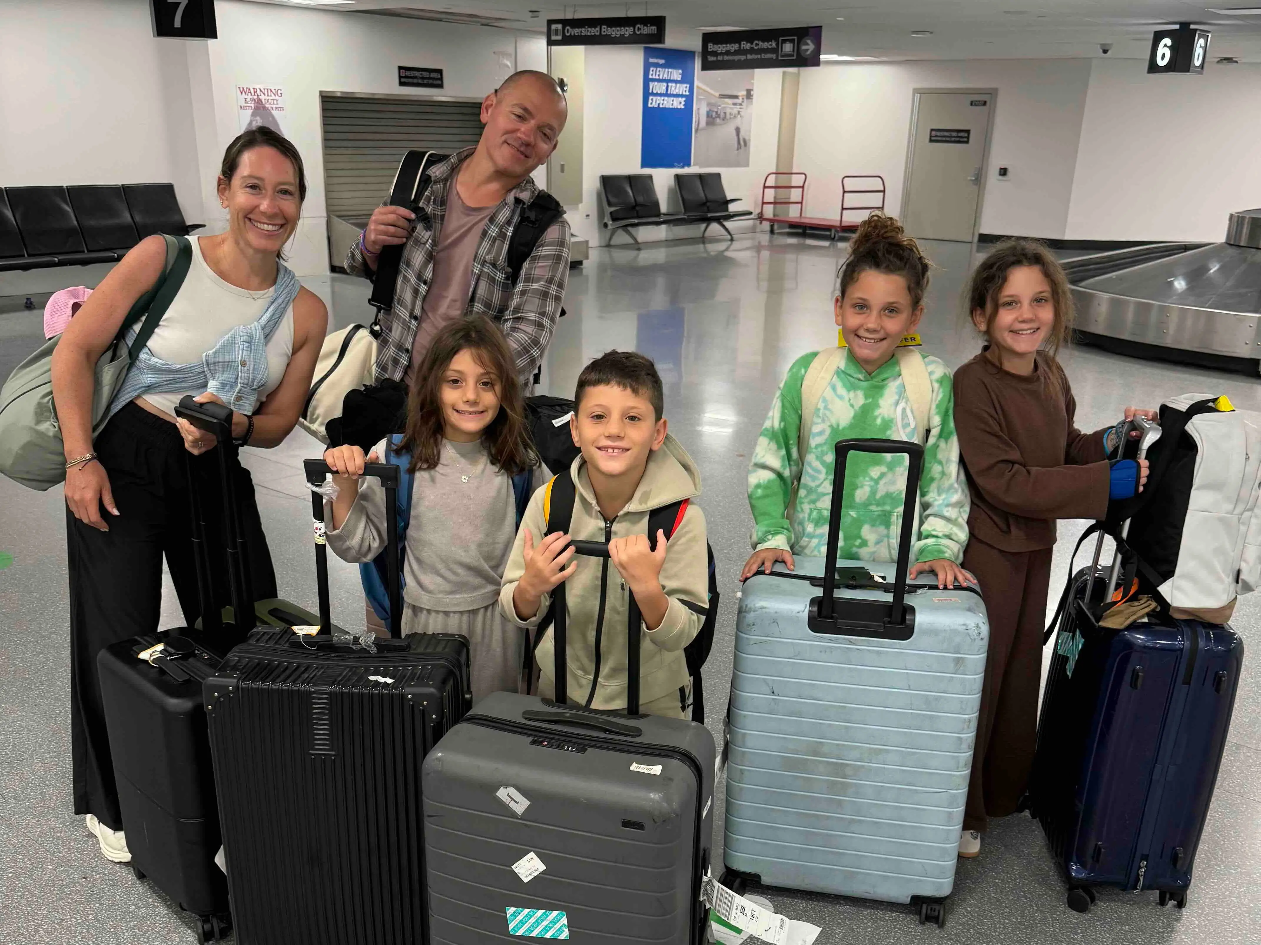 A family of six at an aiport in Boston.