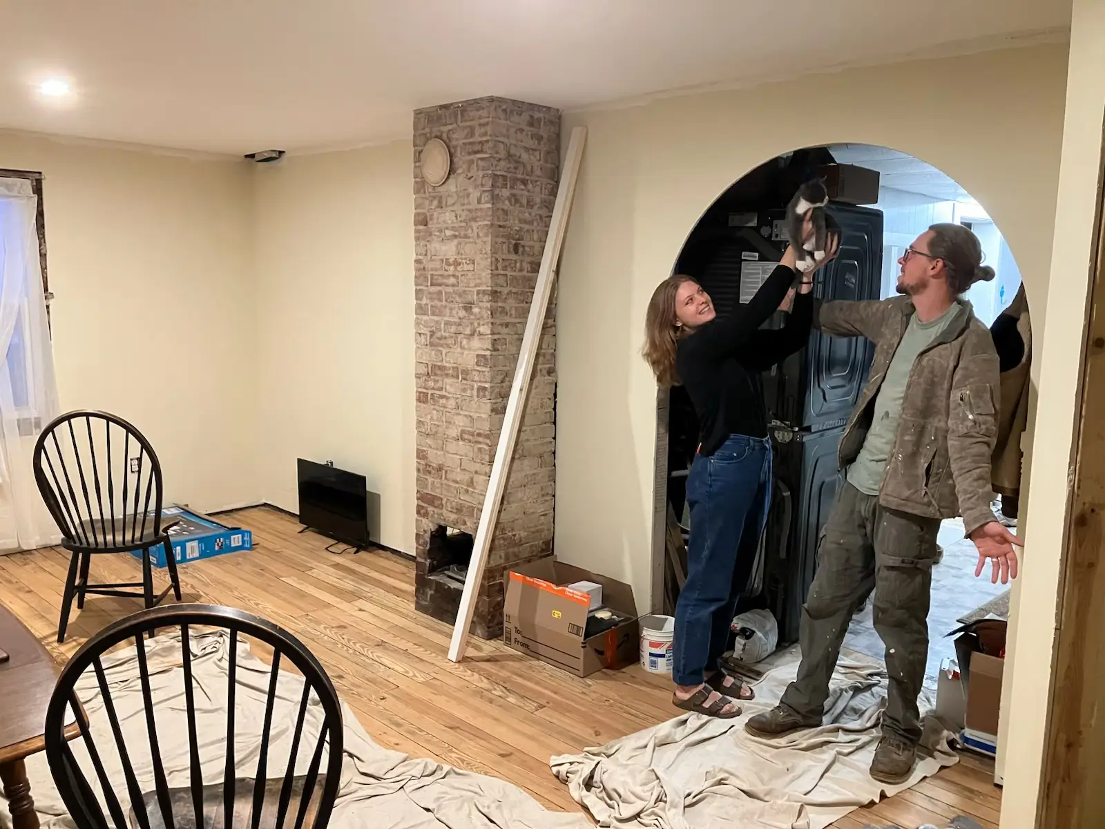 The writer and her husband are standing in the completed archway in their home.