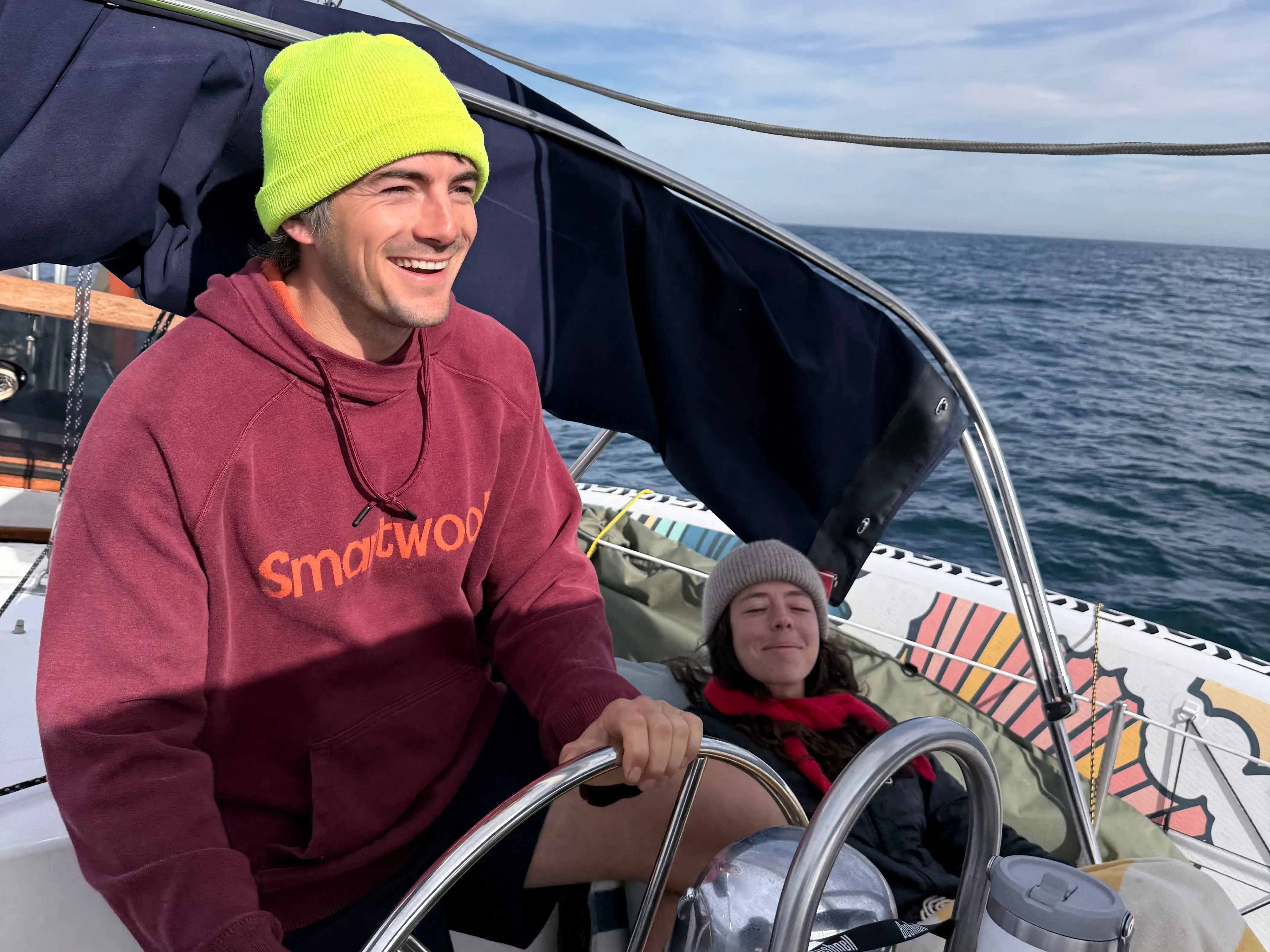 The writer and her husband sail on open water on their sailboat.