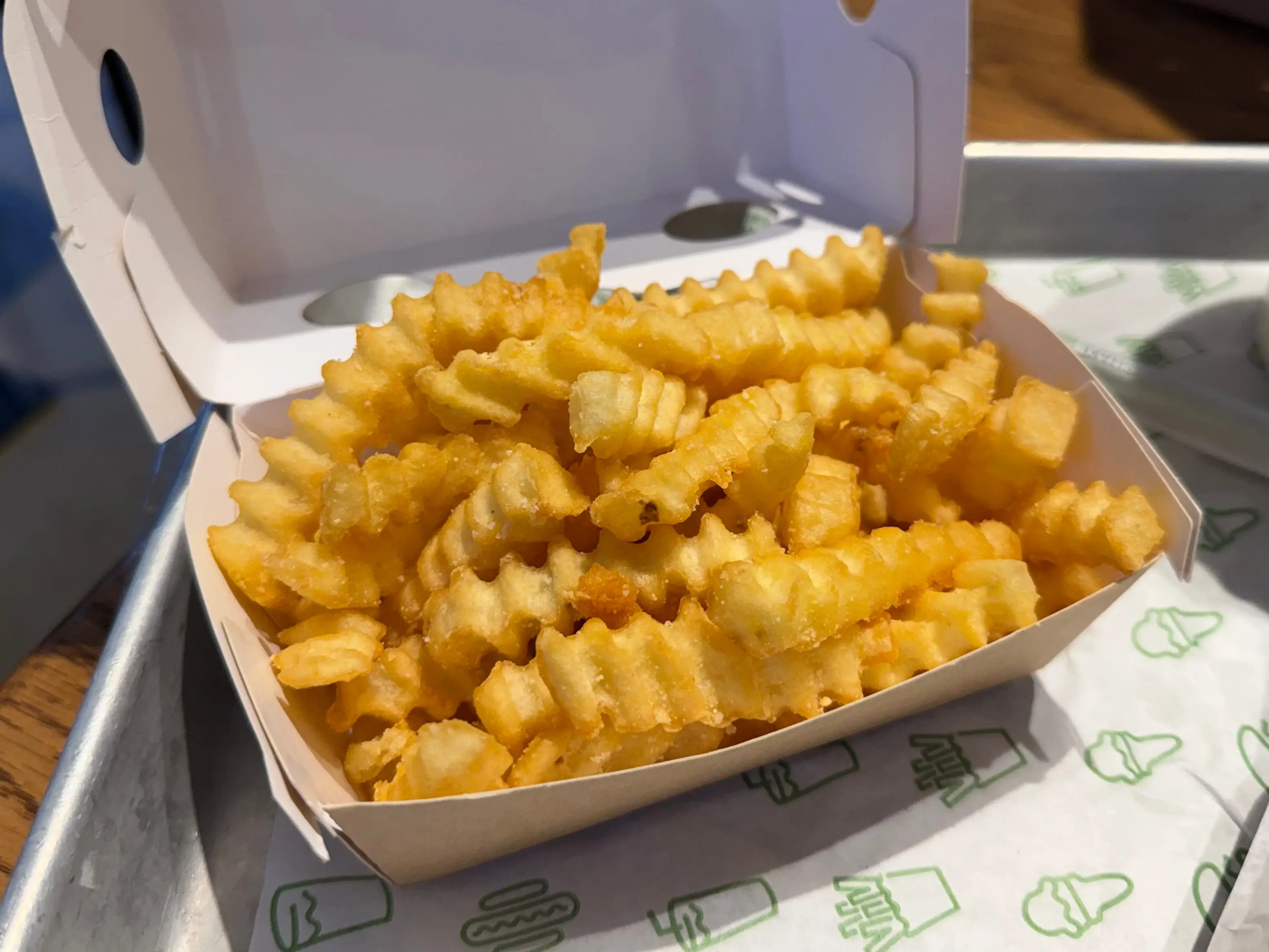 A container of crinkle-cut fries.