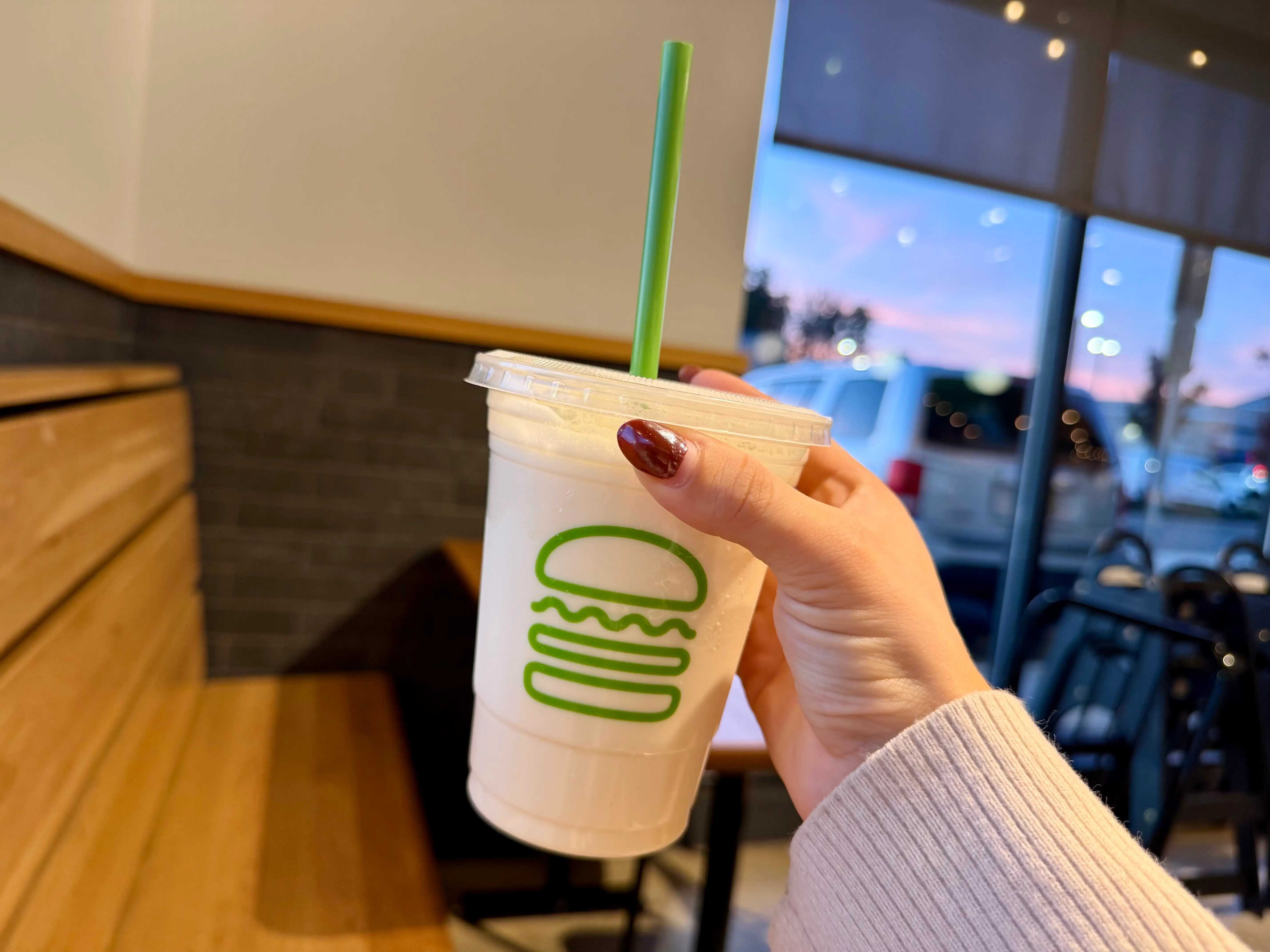 Amanda holds a vanilla milkshake.