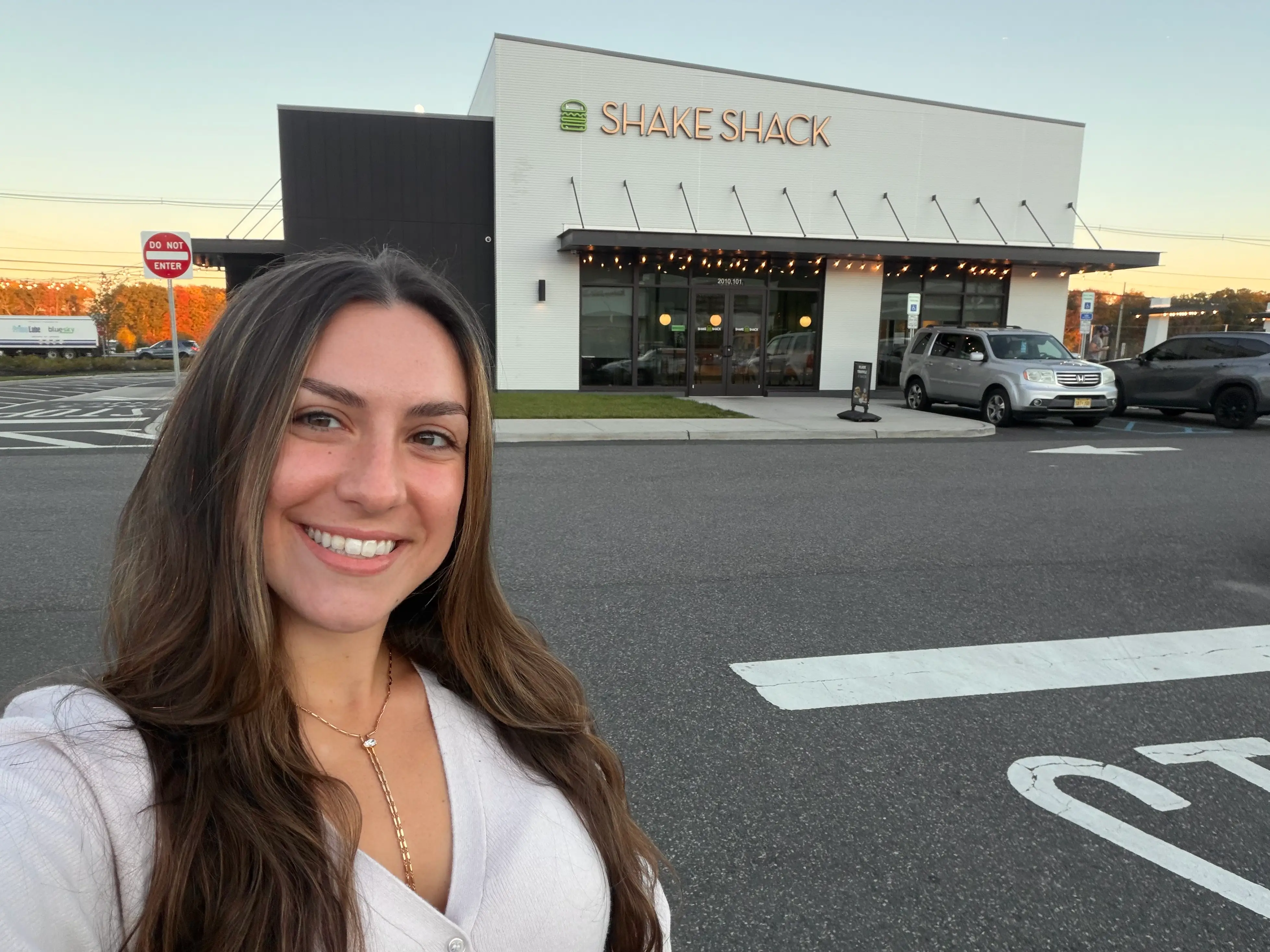 Amanda stands outside a Shake Shack restaurant.