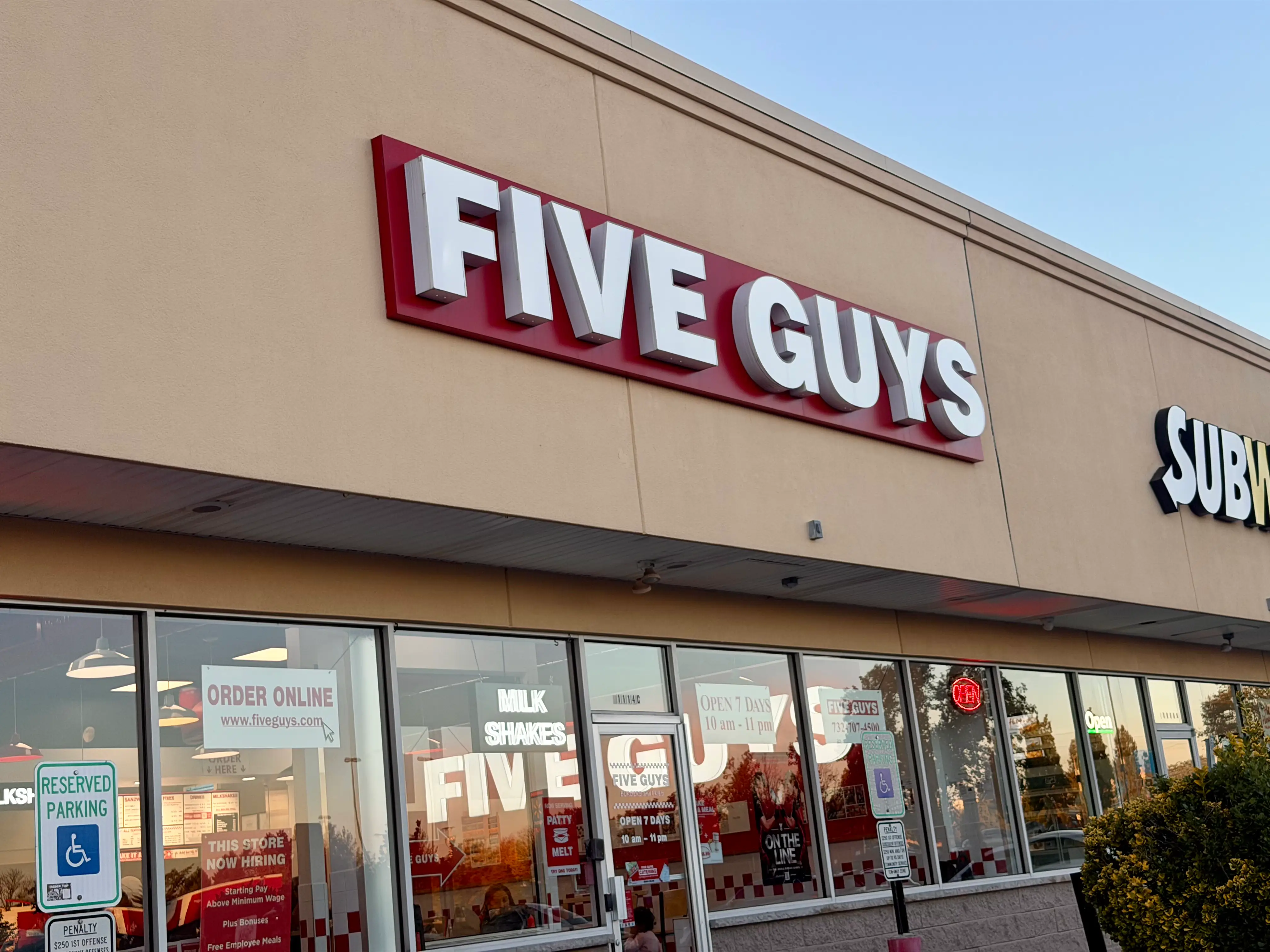 The exterior of a Five Guys restaurant.