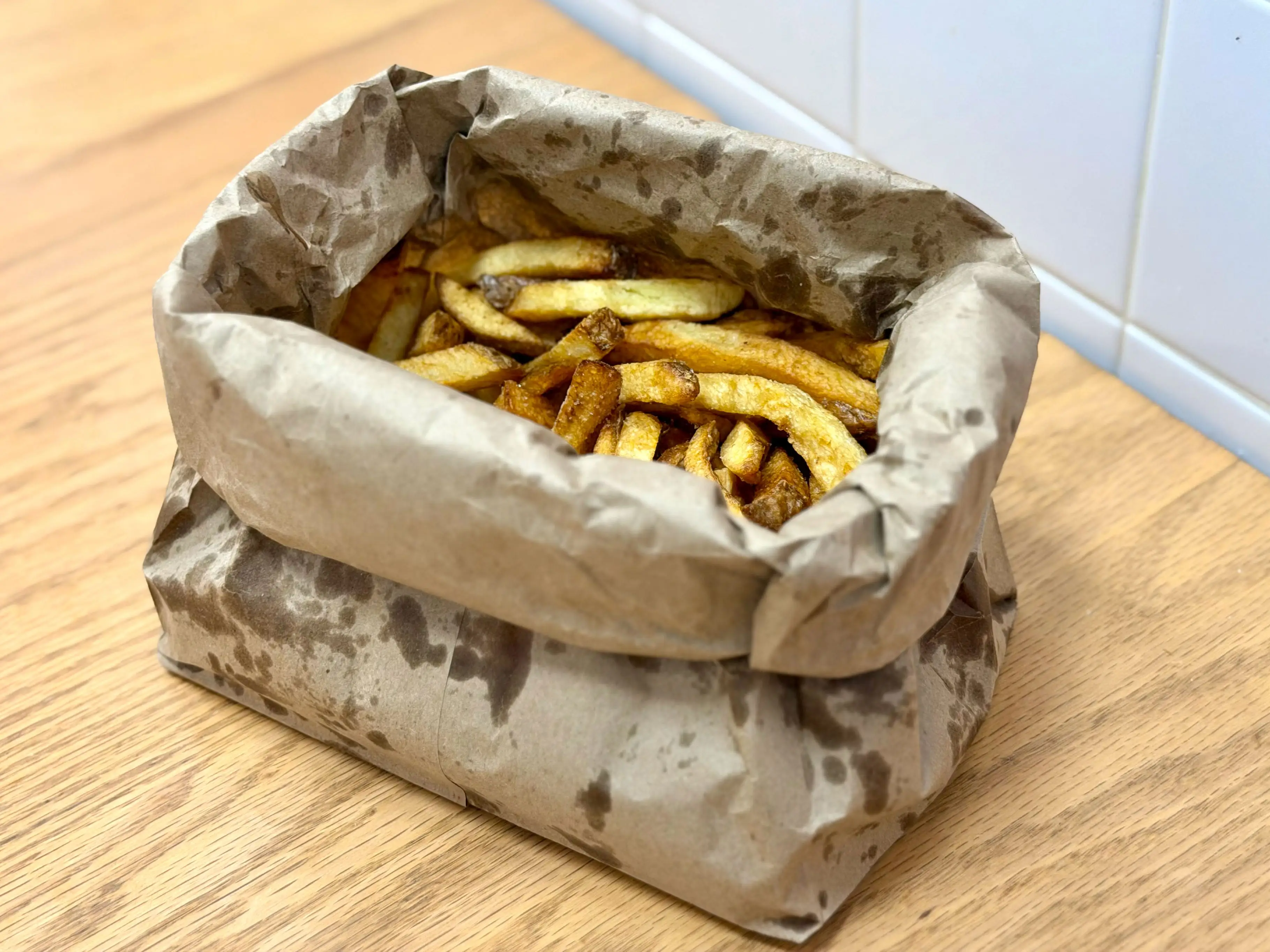 A bag of fries on a table.