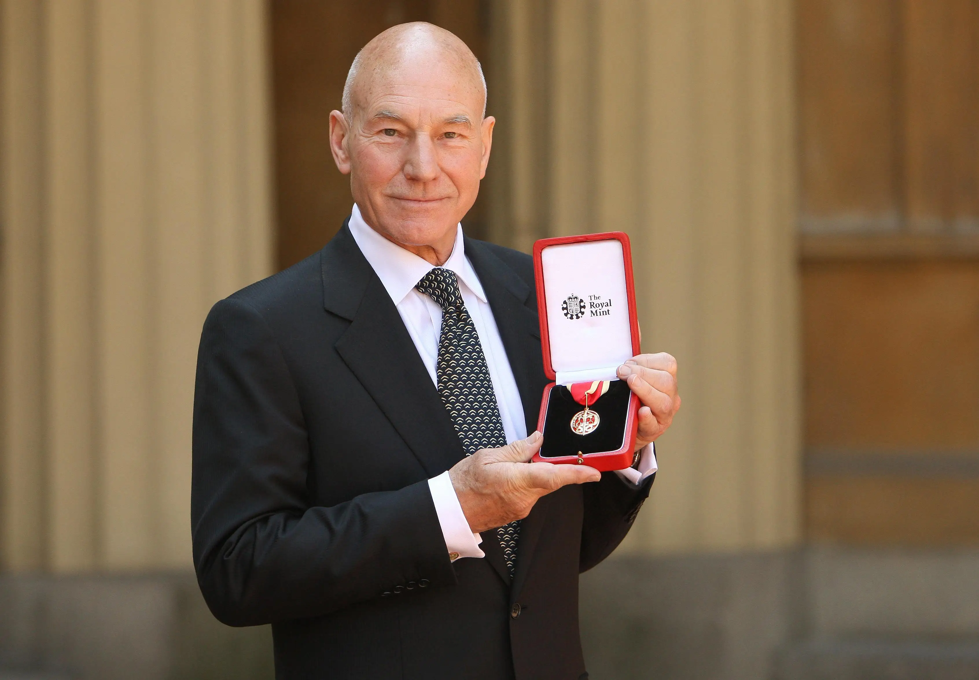 Actor Sir Patrick Stewart poses with his award after he was Knighted by Britain's Queen Elizabeth II at Buckingham PalaceJune 02, 2010 in London, England