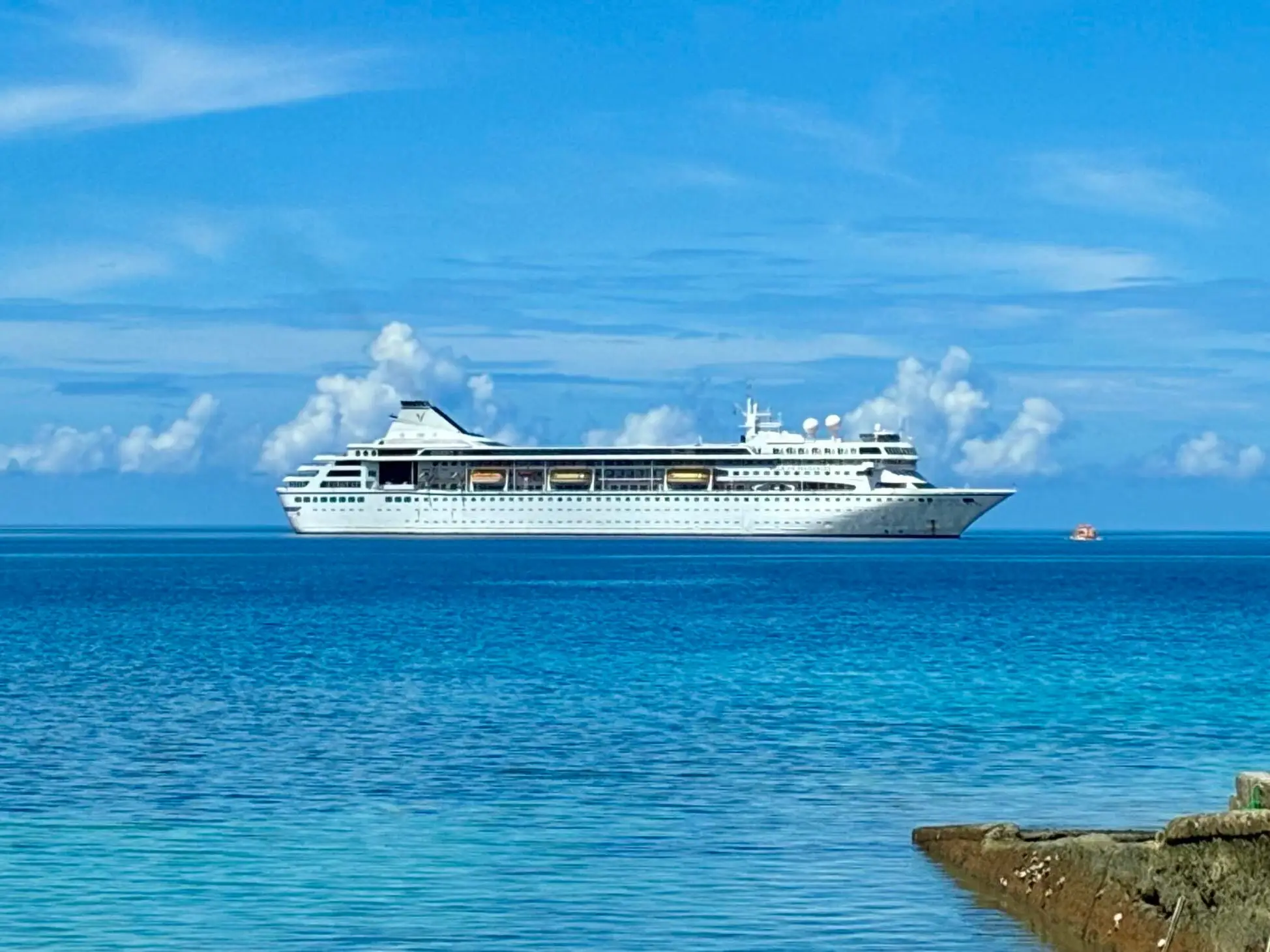 A ship on the ocean, as seen from shore