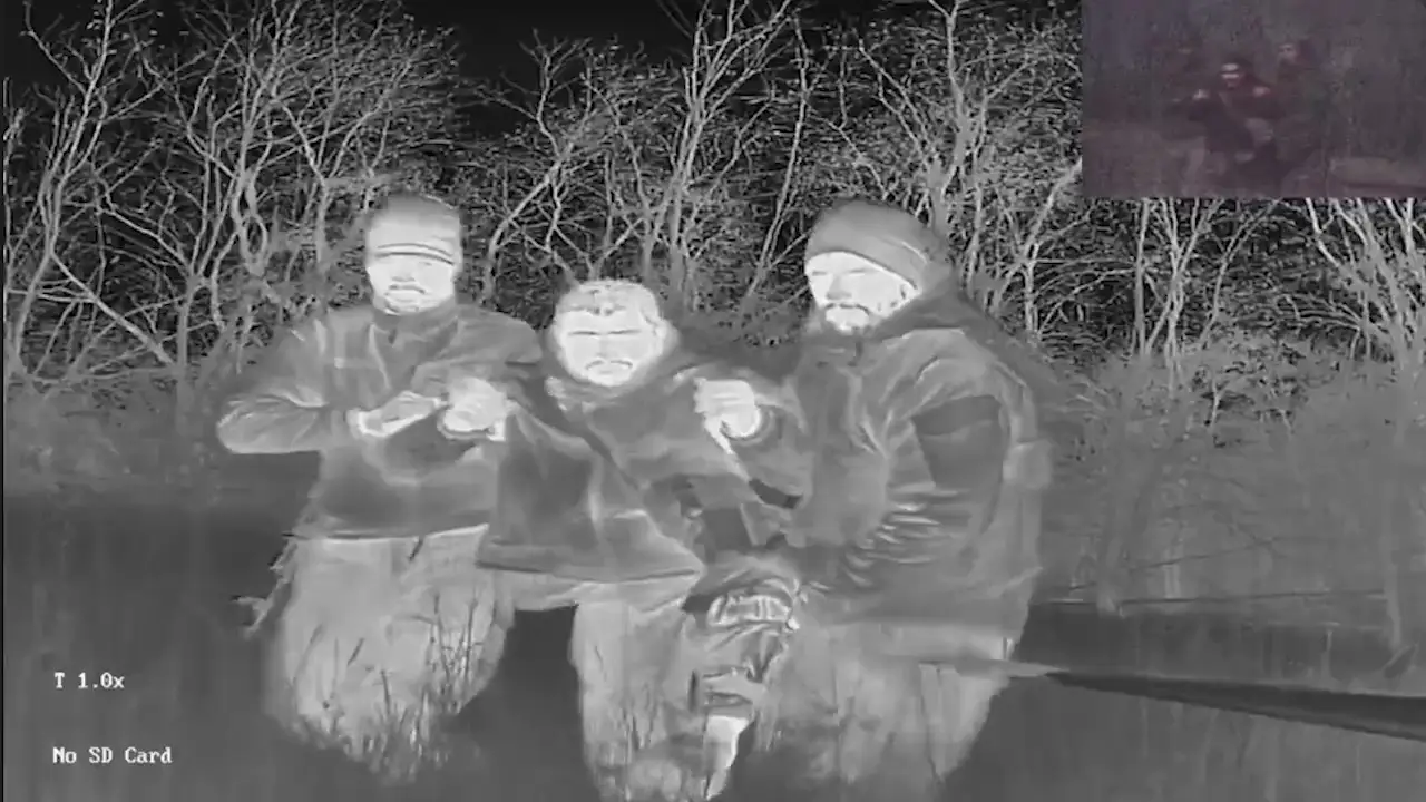 Ukrainian soldiers helping an injured comrade to a drone.