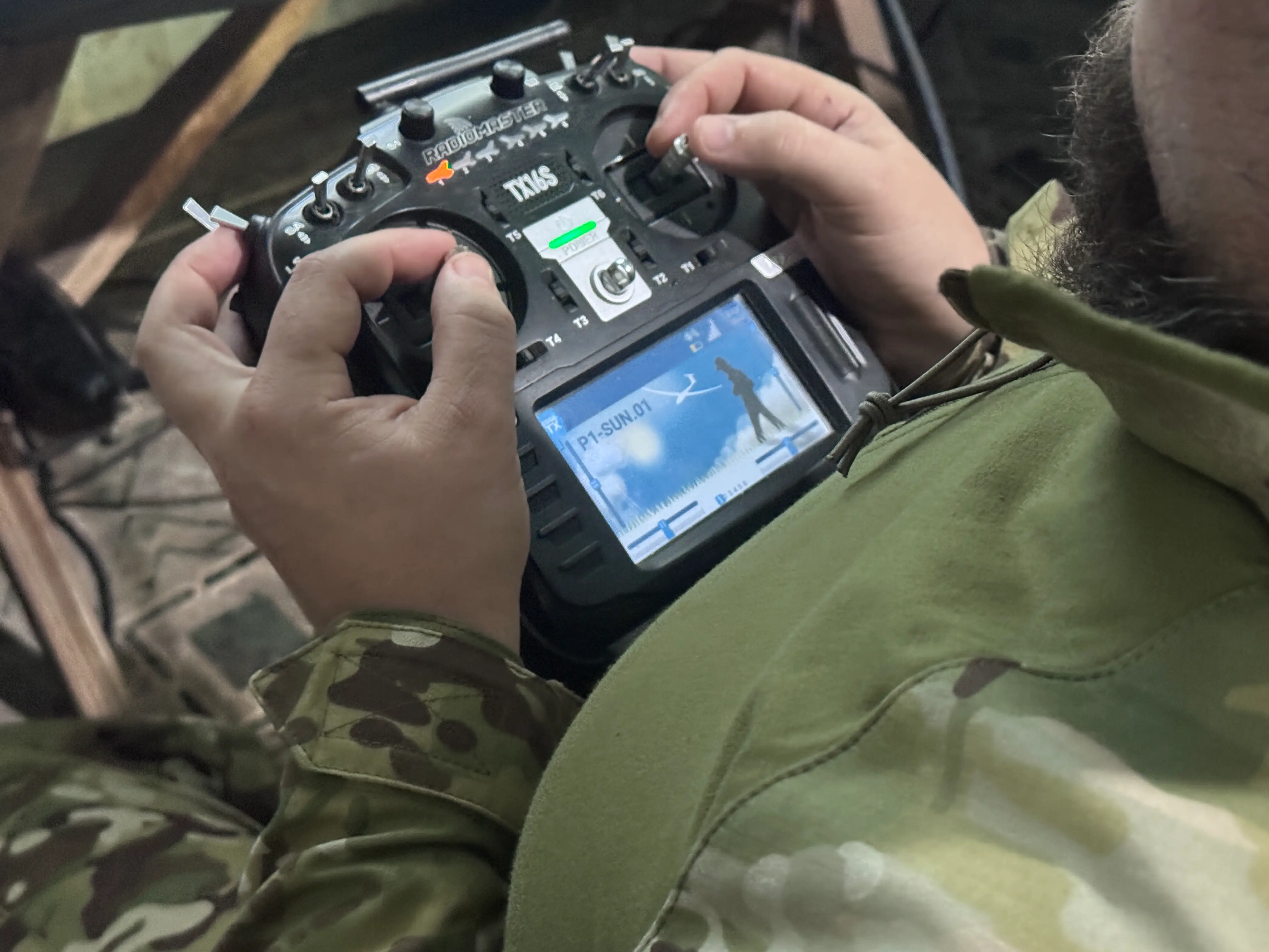 A Ukrainian soldier holds a remote control for a drone.