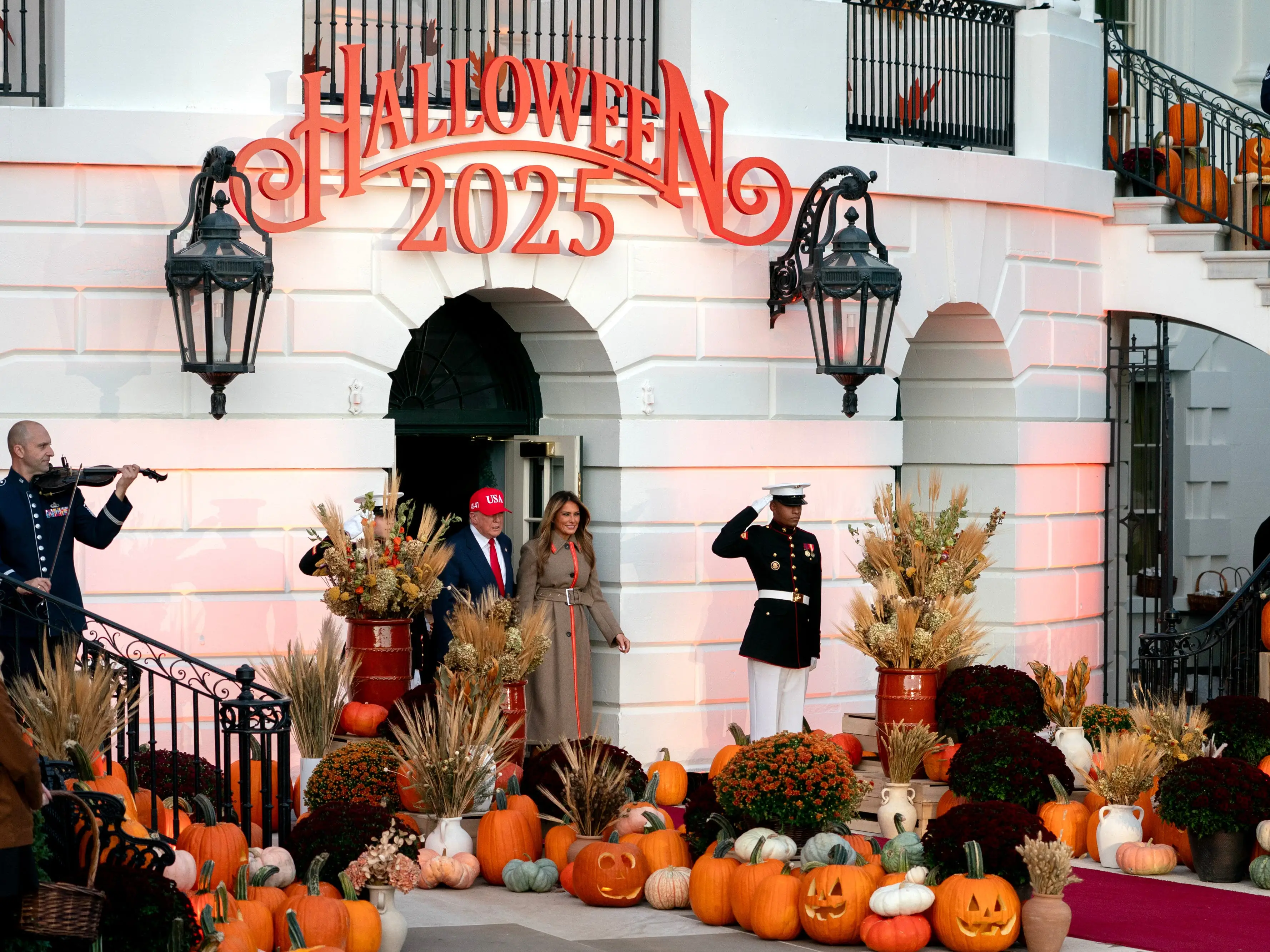 US President Donald Trump, center left, and First Lady Melania Trump, center right, arrive for a Halloween event on the South Lawn of the White House in Washington, DC, US, on Thursday, Oct. 30, 2025.