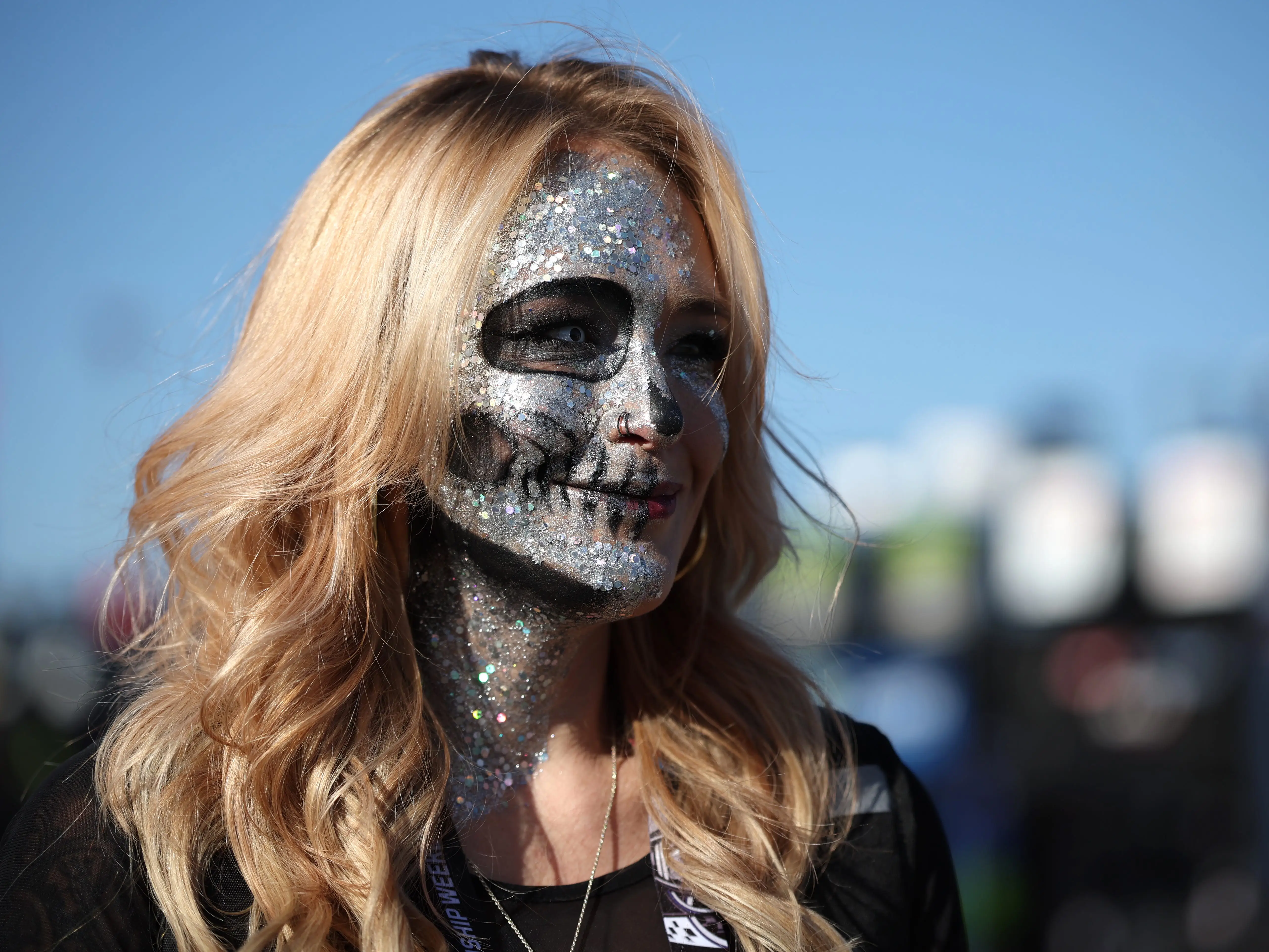 A NASCAR fan with Halloween make-up walks the grid during practice for the NASCAR Cup Series Championship at Phoenix Raceway on October 31, 2025 in Avondale, Arizona.