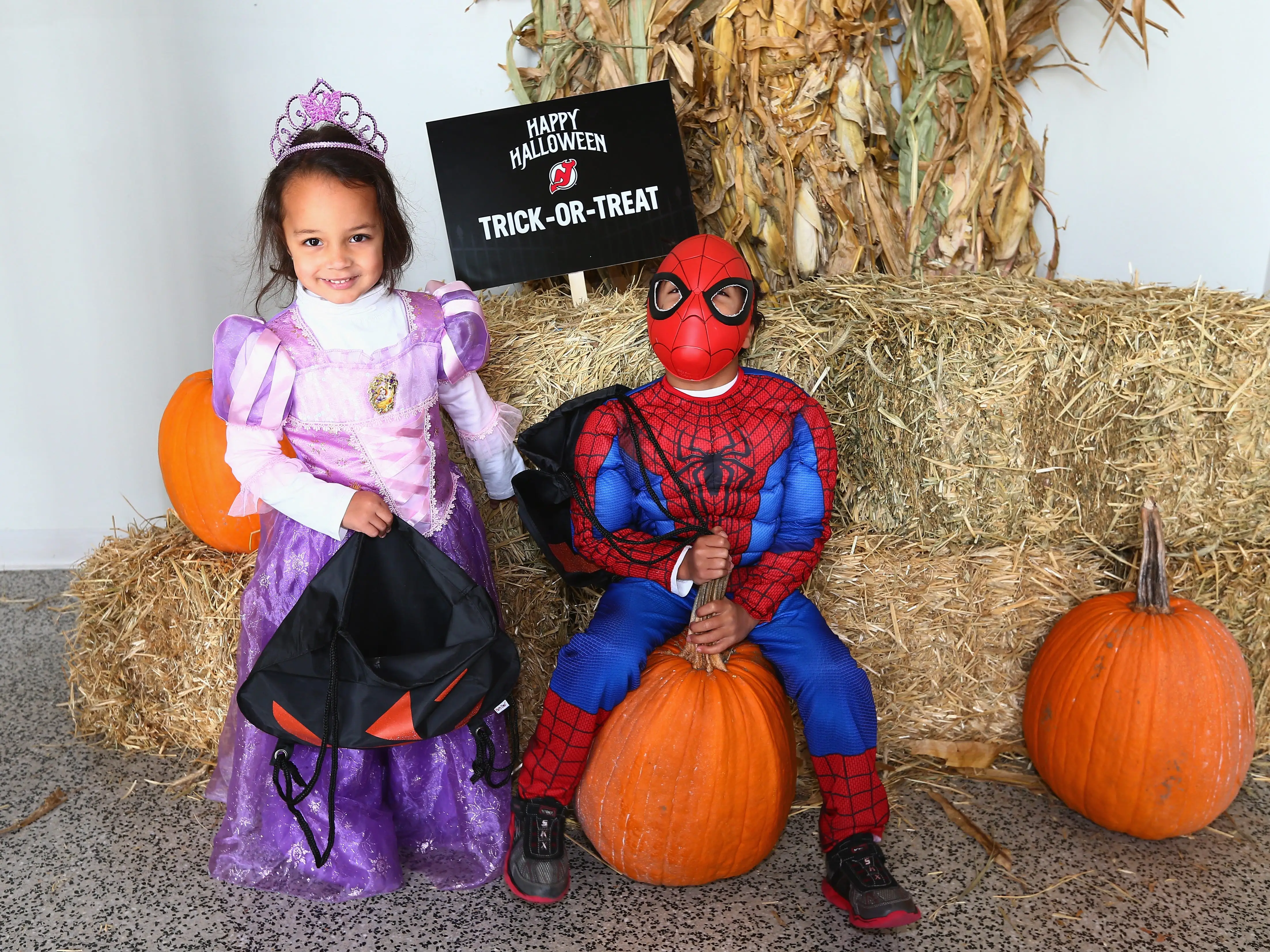 Children pose for a photo during Halloween festivities prior to the game between the New Jersey Devils and the New York Islanders at the Prudential Center on October 31, 2015 in Newark, New Jersey.