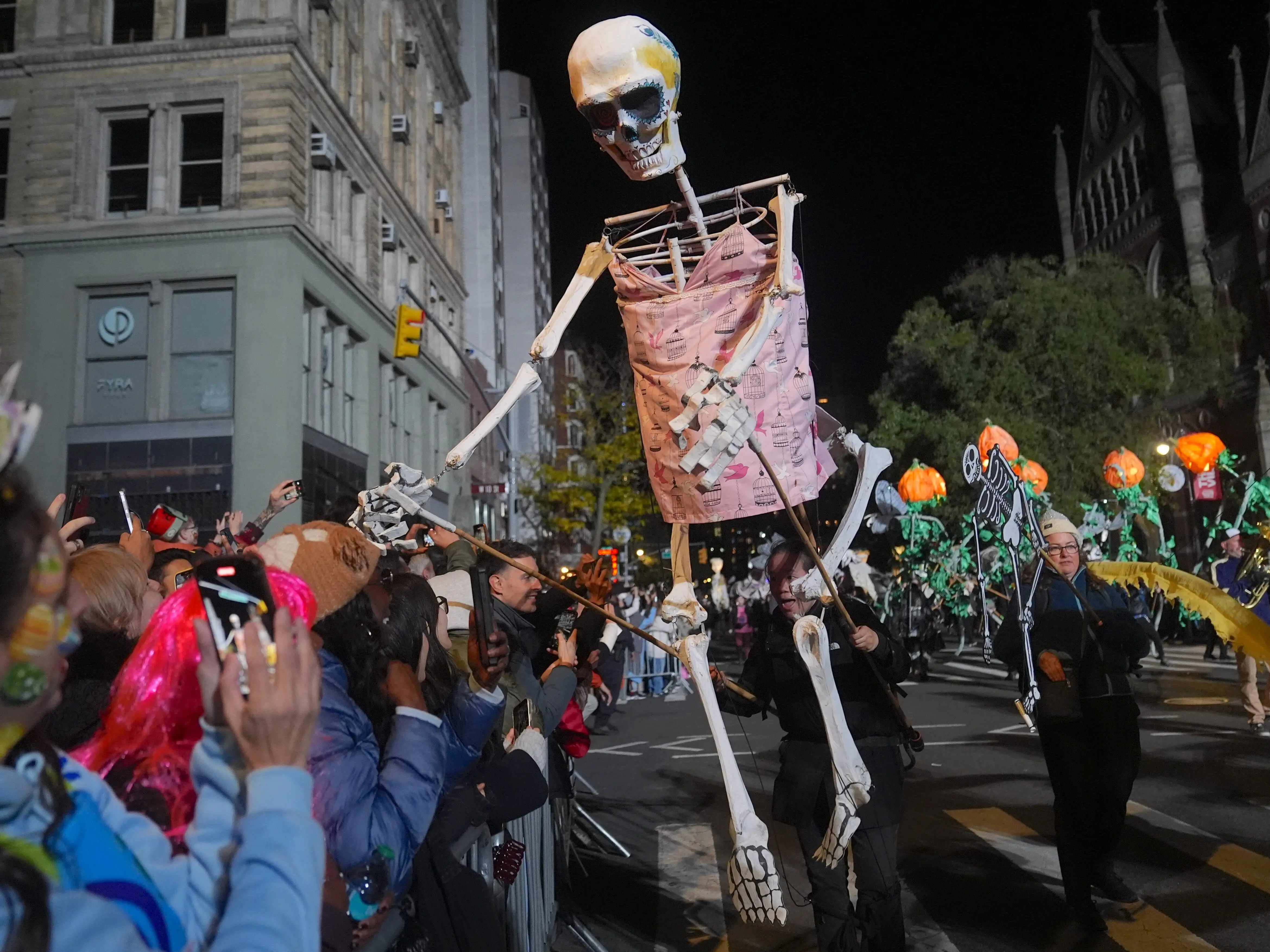 People attend in costume at the 52nd Annual Village Halloween Parade on Friday night, October 31, 2025, in New York City, United States