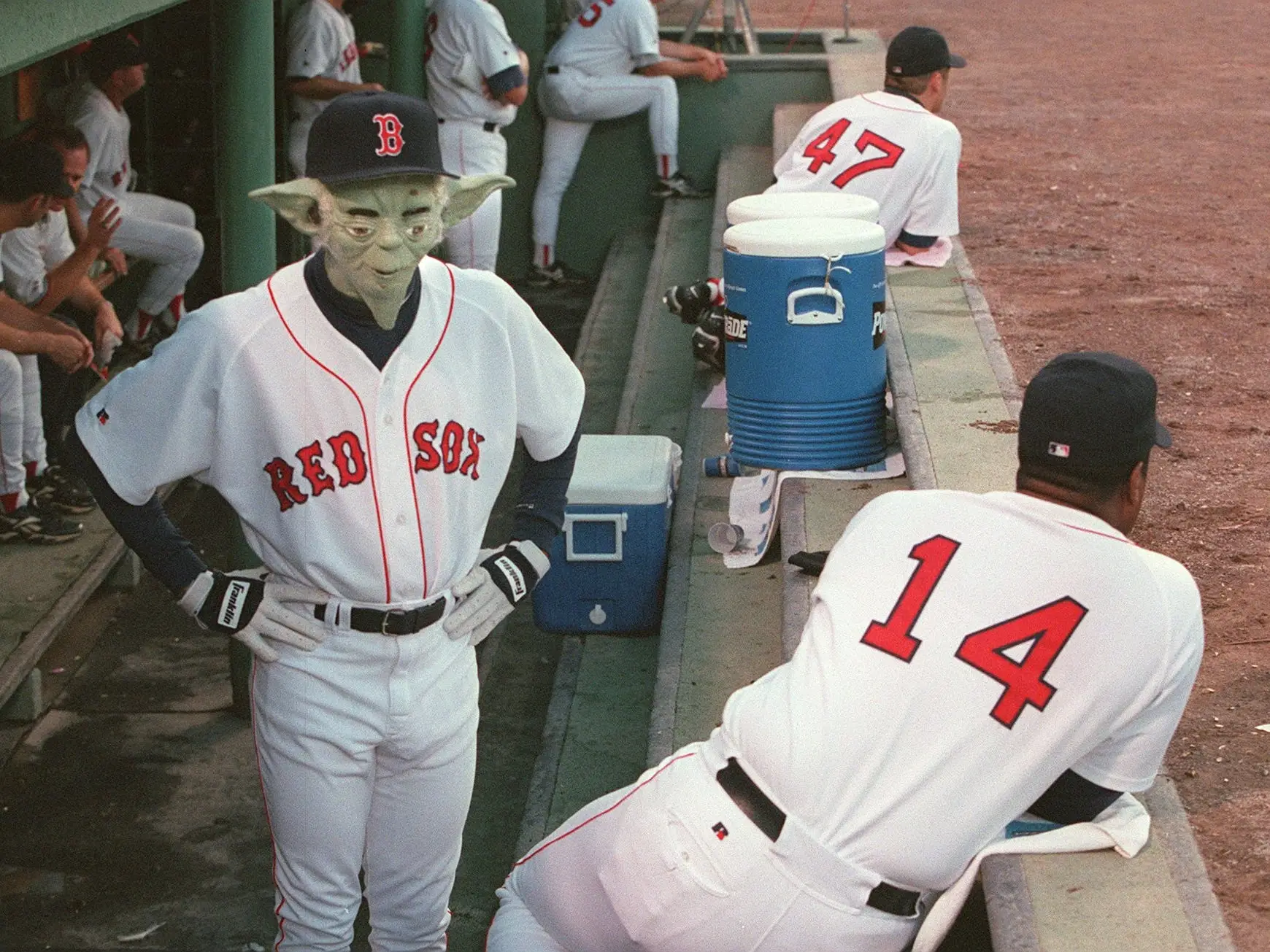 Pedro Martinez wearing injured Red sox (#41) Jim Consi's number while entertaining teammates by coming out into dugout wearing what appeared to be a 