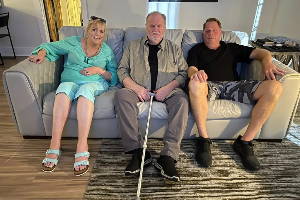 Thomas Markle, Samantha Markle, and Thomas Jr sit together on a light-colored sofa.