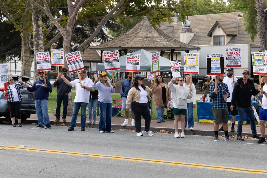 Teamsters Local 986 union members holding strike signs in Solvang.