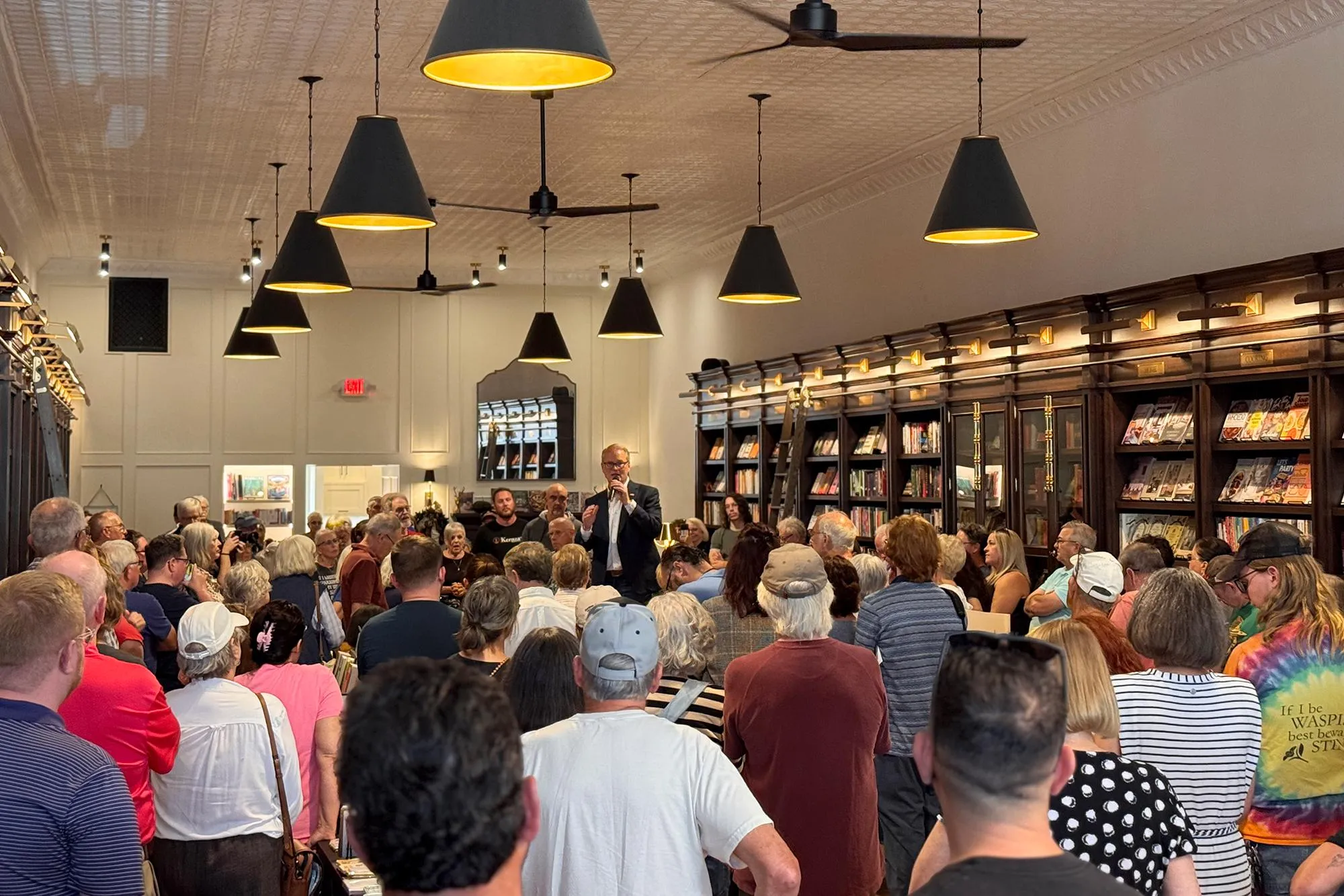 a wide view of a book store filled with people listening to Adam Hamilton speaking in the center a wide view of a book store filled with people listening to Adam Hamilton speaking in the center