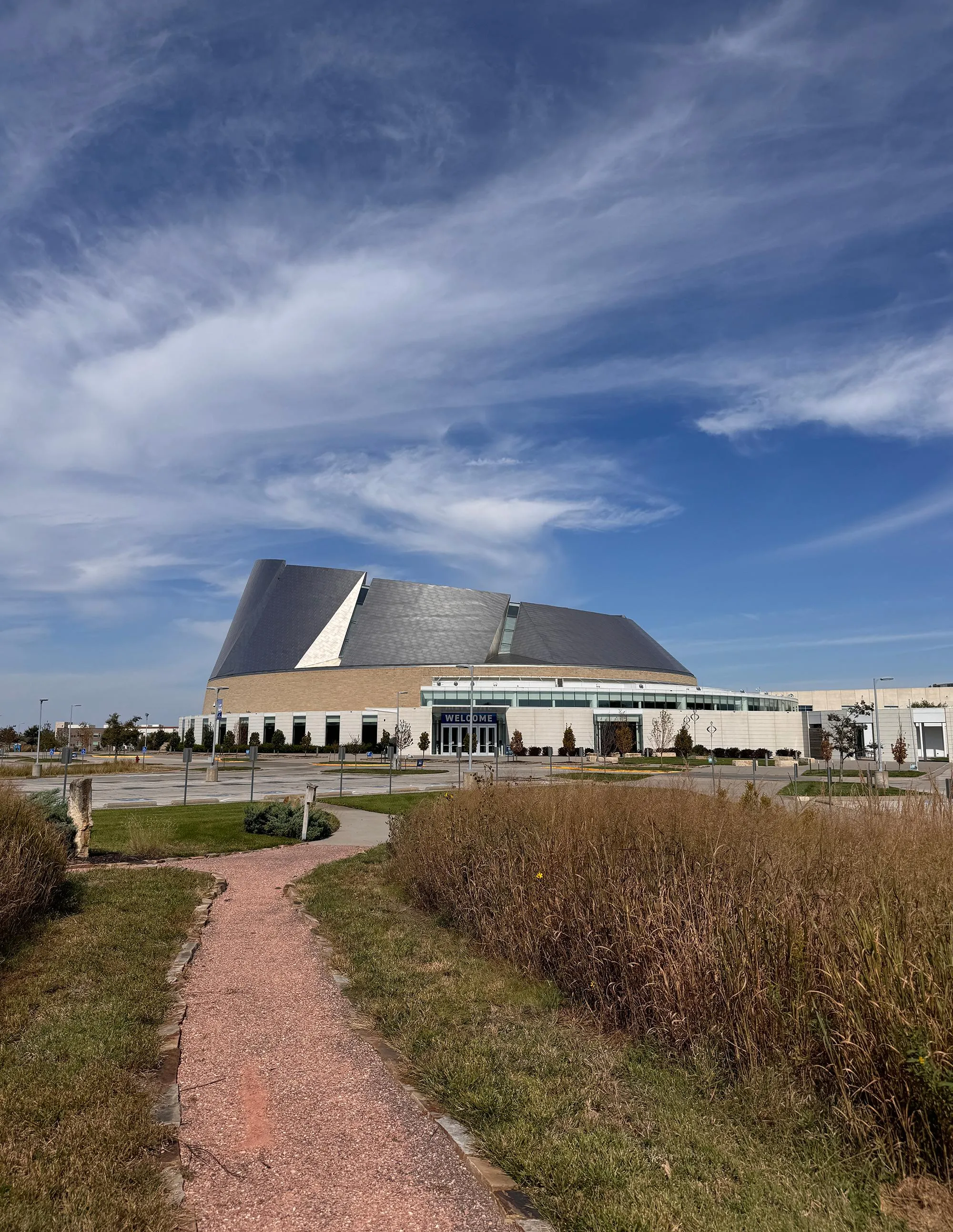 a big spaceship-looking church beyond tall grass. a big spaceship-looking church beyond tall grass.