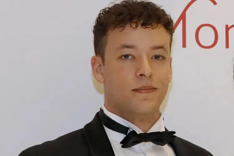 Antoine De Massy wearing a tuxedo.