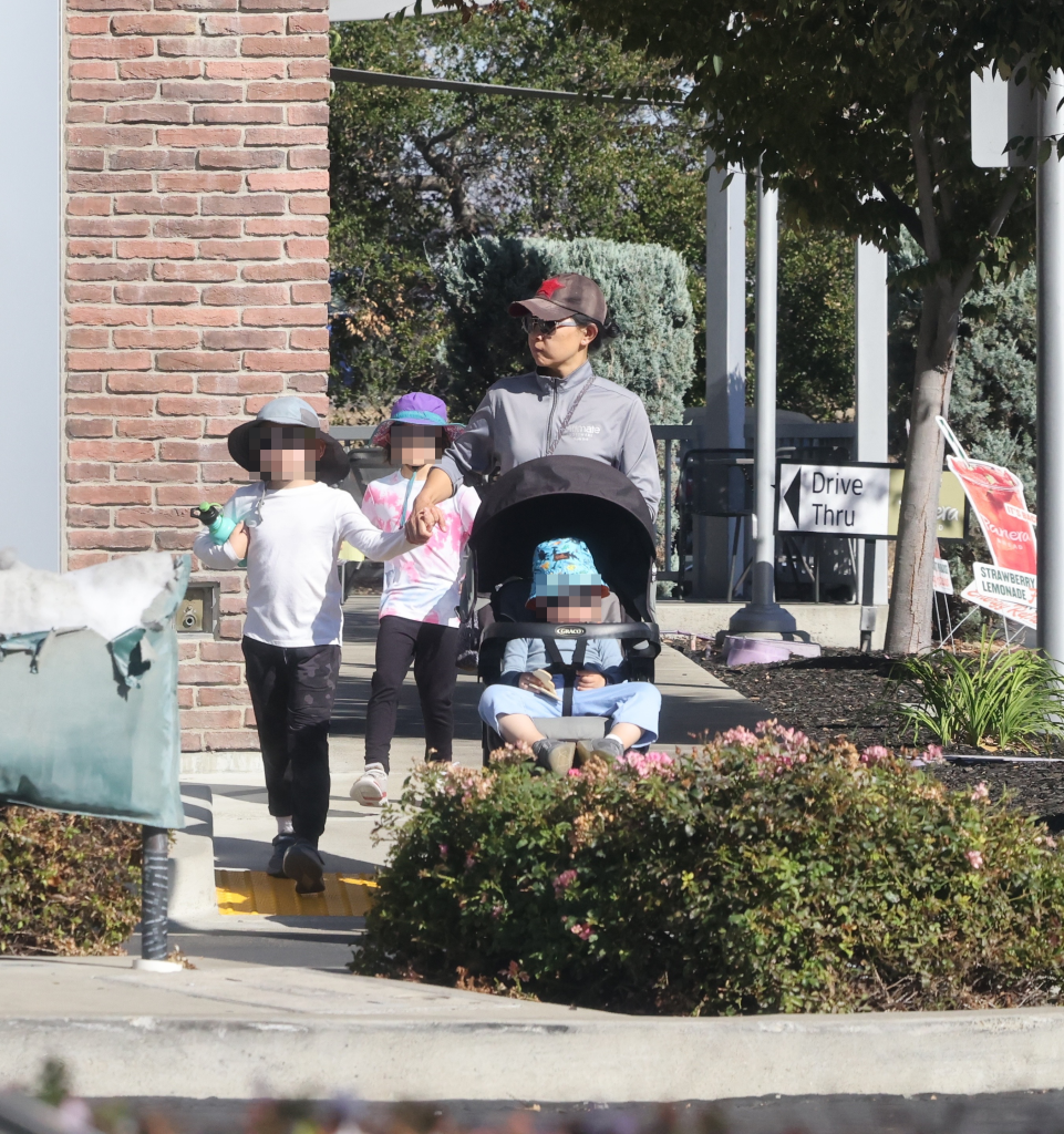 Candice Jang walking outdoors with her children.
