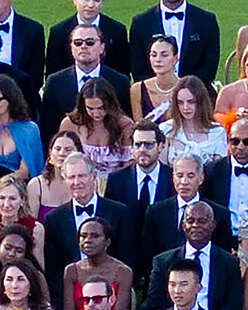 Leonardo DiCaprio and other guests attending a formal outdoor event.