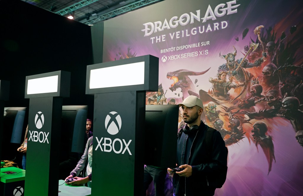 A gamer plays the video game 'Dragon age the veilguard' developed by BioWare and published by Electronic Arts on Xbox console during the 'Paris Games Week' on October 22, 2024 in Paris, France.