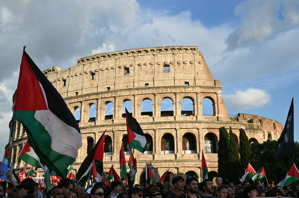 Protesters wave Palestinian flags in front of the Colosseum in Rome.