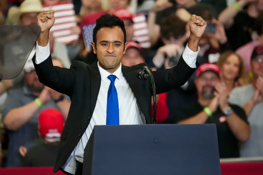 Ohio gubernatorial candidate Vivek Ramaswamy raises his fists in the air at a podium during a rally at the Shoemaker Center.