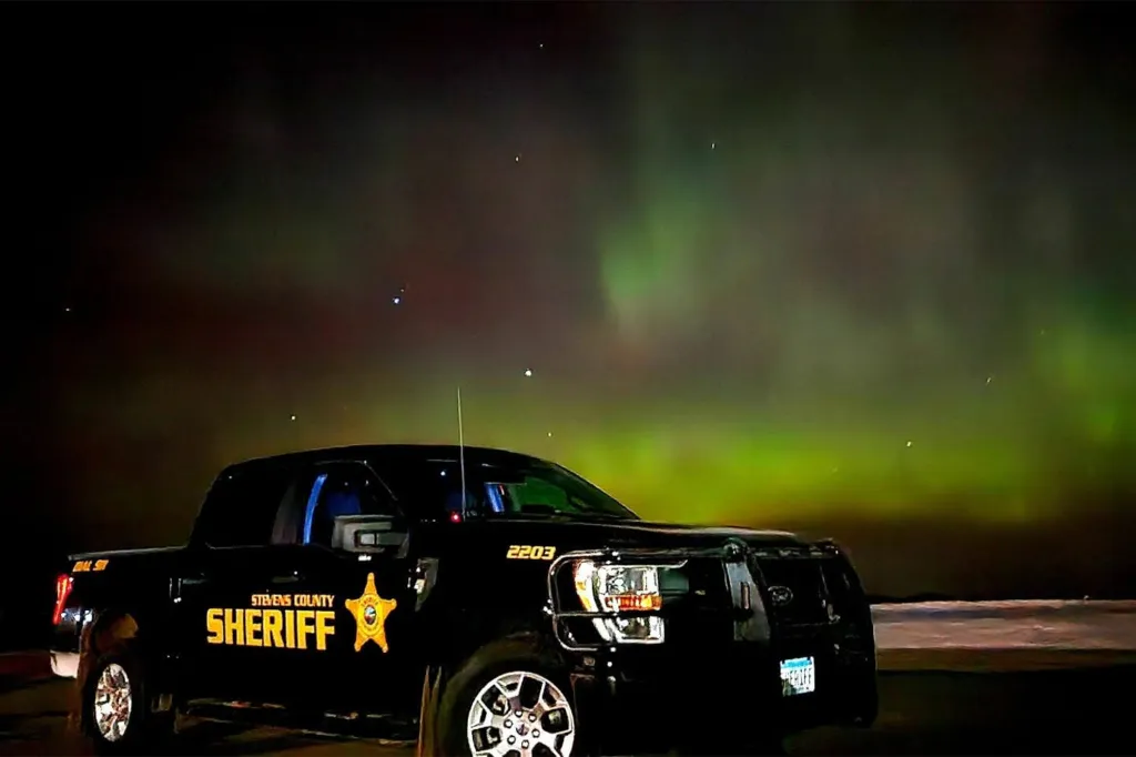 A Stevens County Sheriff's patrol truck parked under the northern lights.