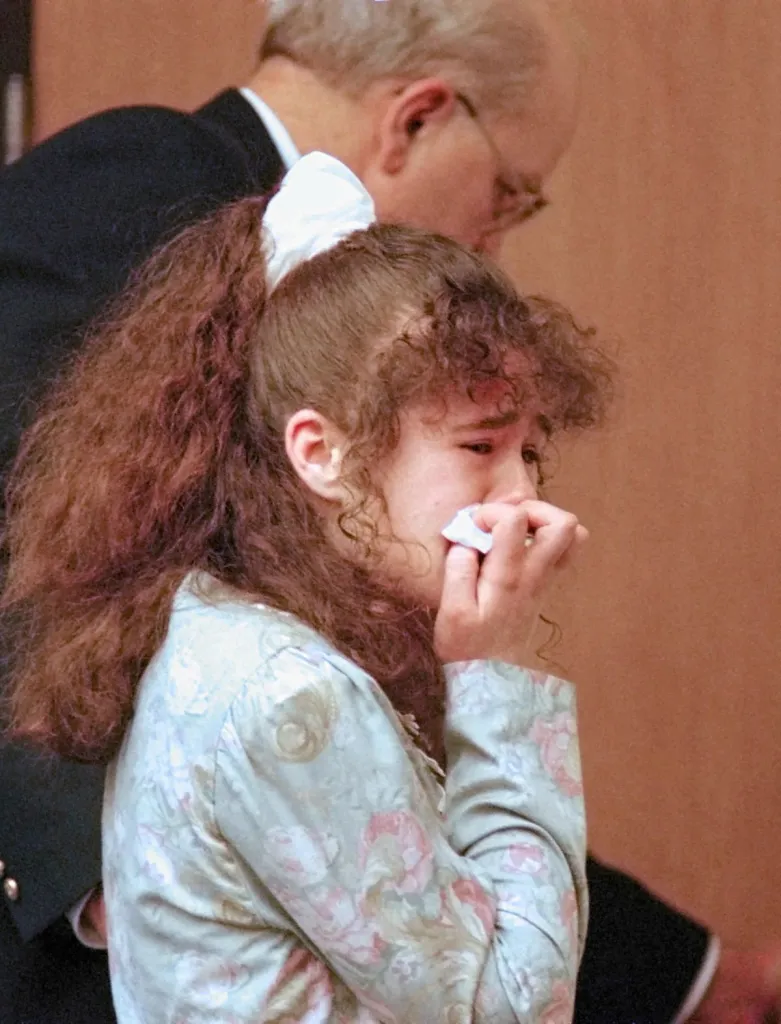 Christa Pike wipes tears from her face while being escorted from Knox County Criminal Court in Knoxville, Tennessee.