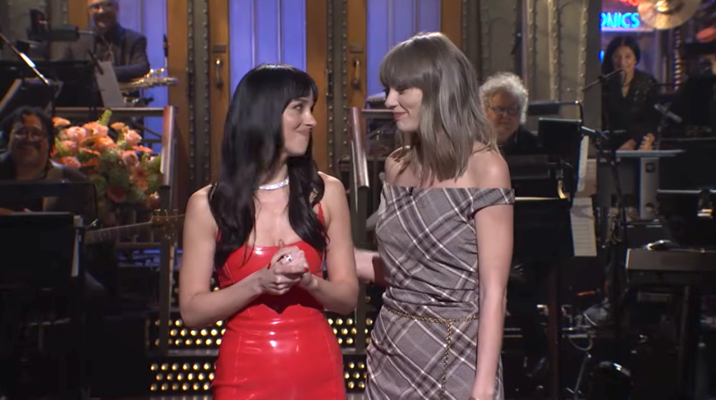 Dakota Johnson and Taylor Swift on stage together.