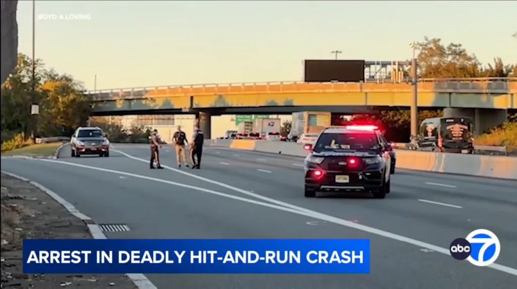Police vehicles and officers investigating a highway crash scene beneath an overpass.