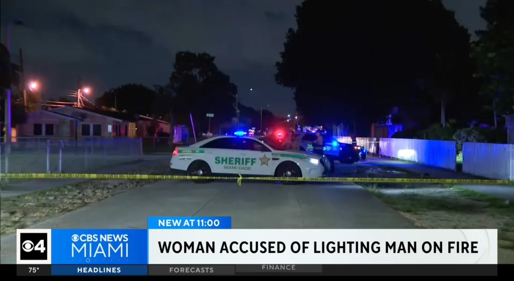 Miami-Dade Sheriff vehicles parked at a night crime scene cordoned off with yellow police tape.
